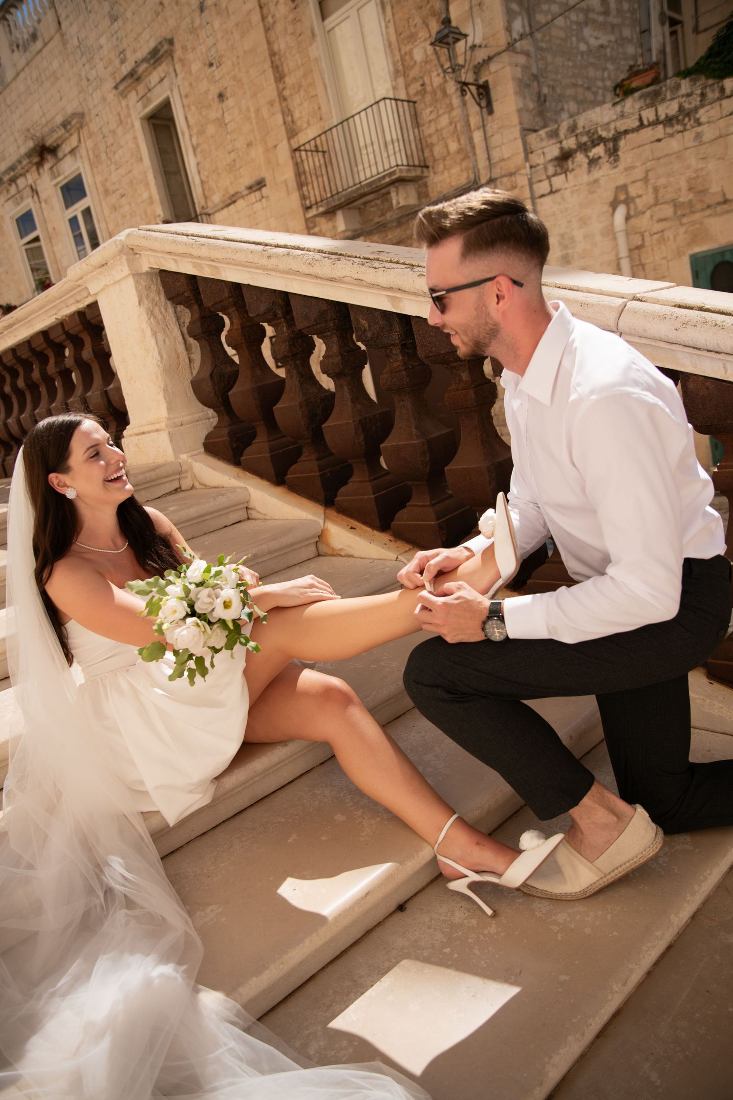 A playful wedding photo session on historic stone steps.