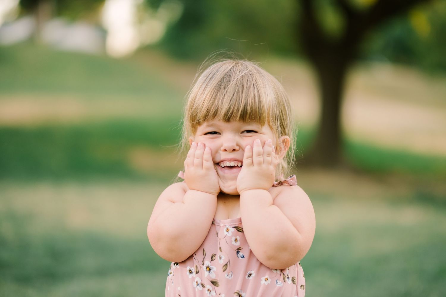 Adorable candid moments of child playing and making faces outdoors.