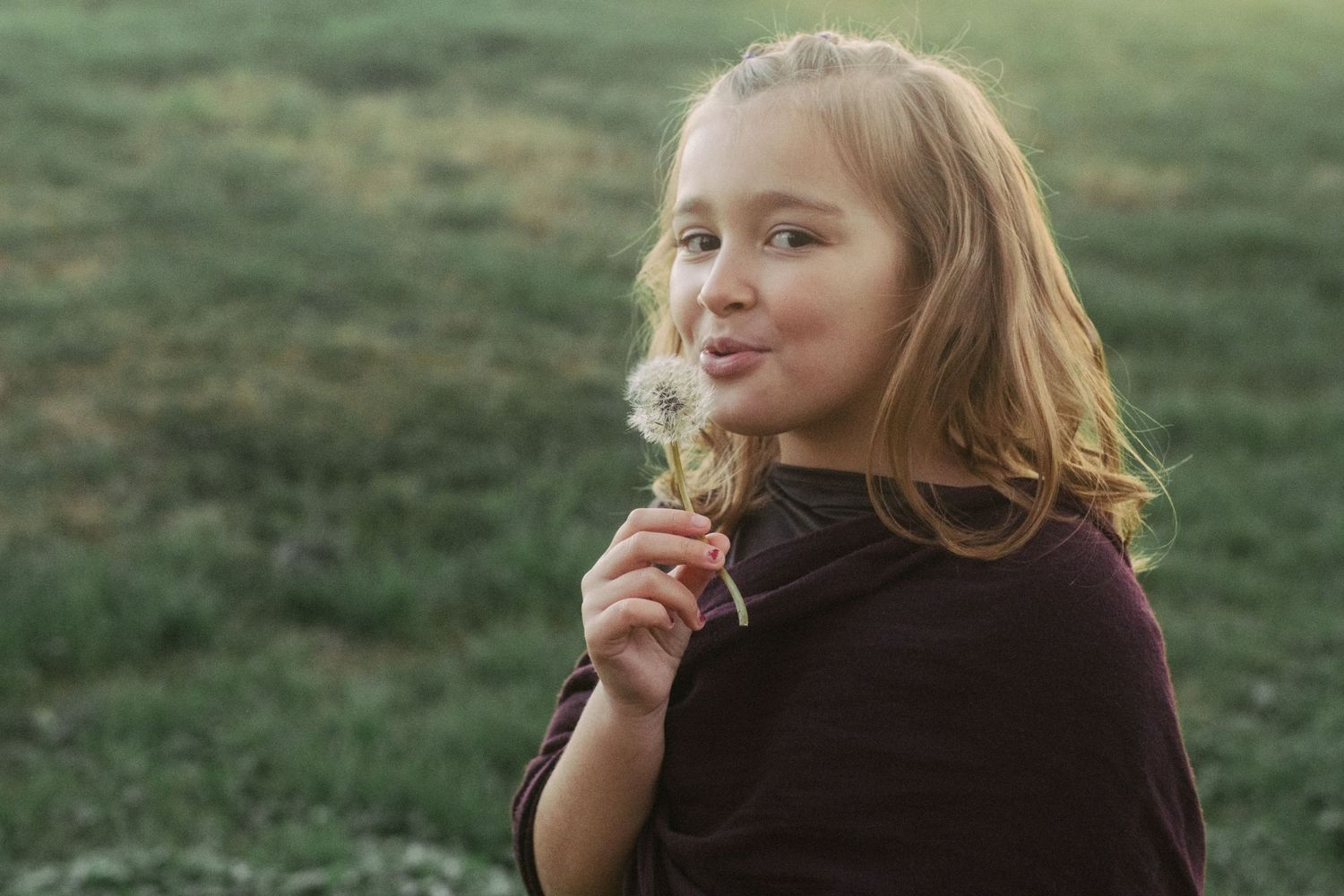 A person snacking outdoors in a peaceful garden setting.
