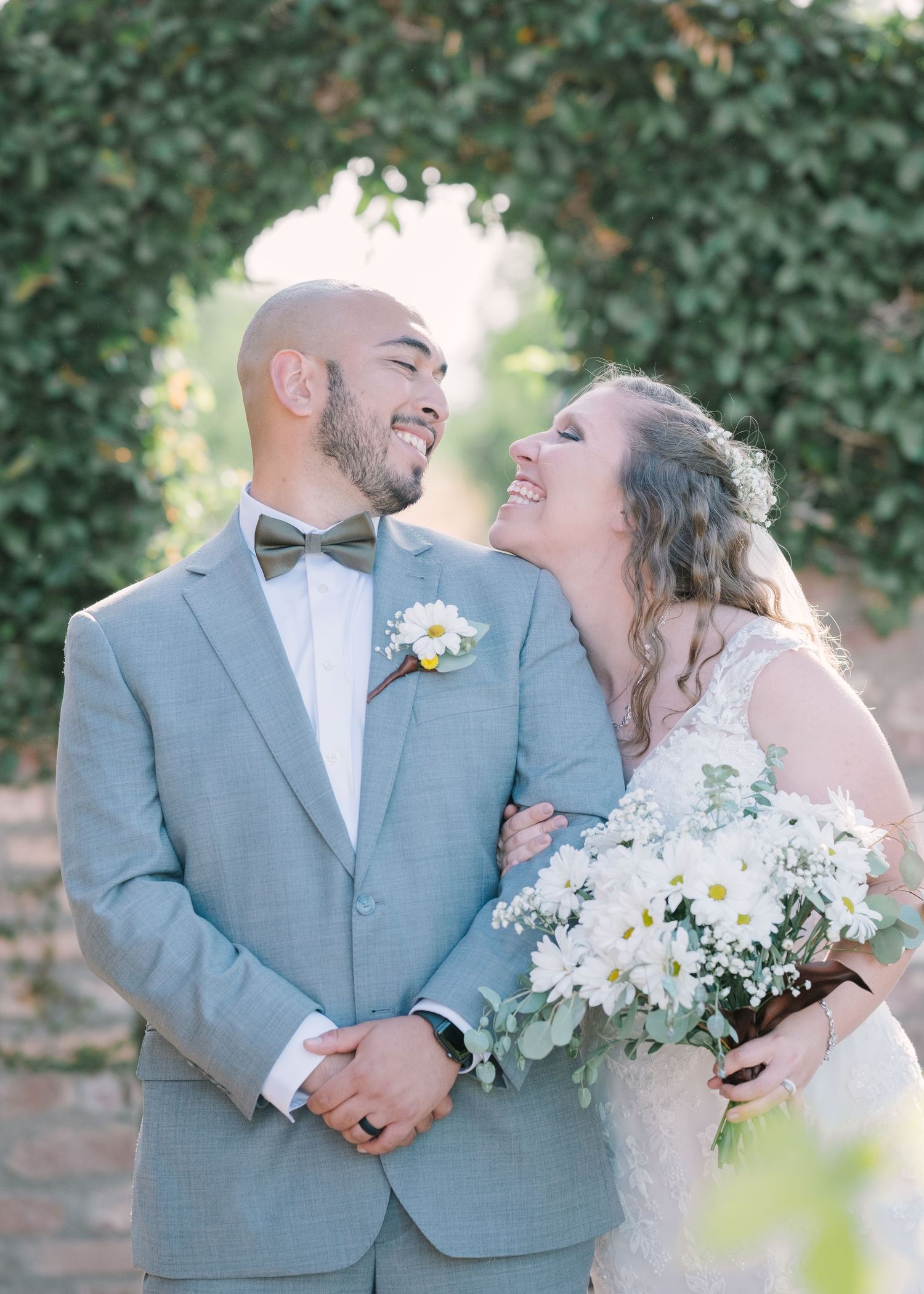 Newlyweds share candid moments with laughter and smiles in a romantic garden photo sequence.