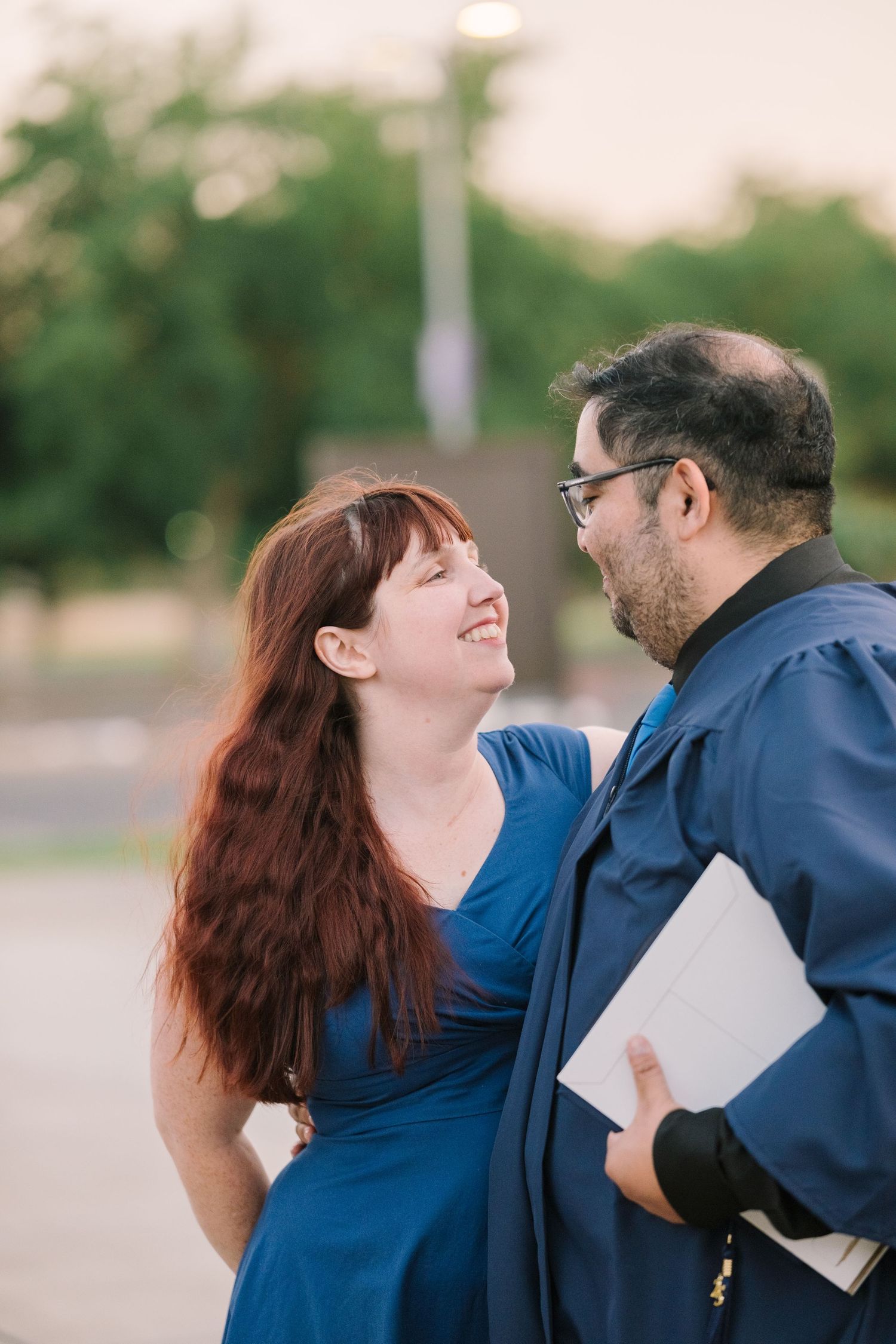 Couple sharing joyful laughter during casual outdoor photo session.