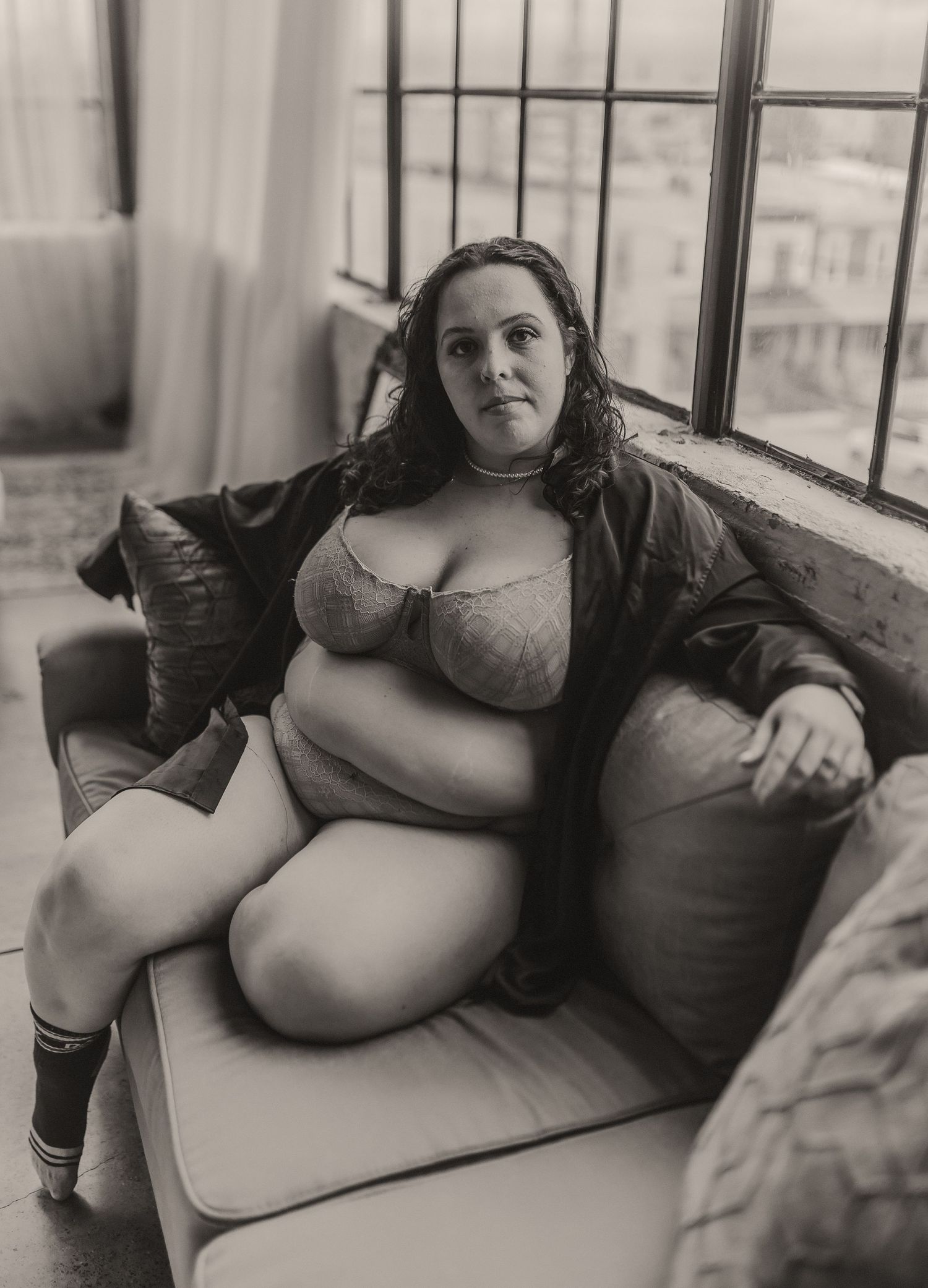Black and white intimate portrait session with natural window lighting.