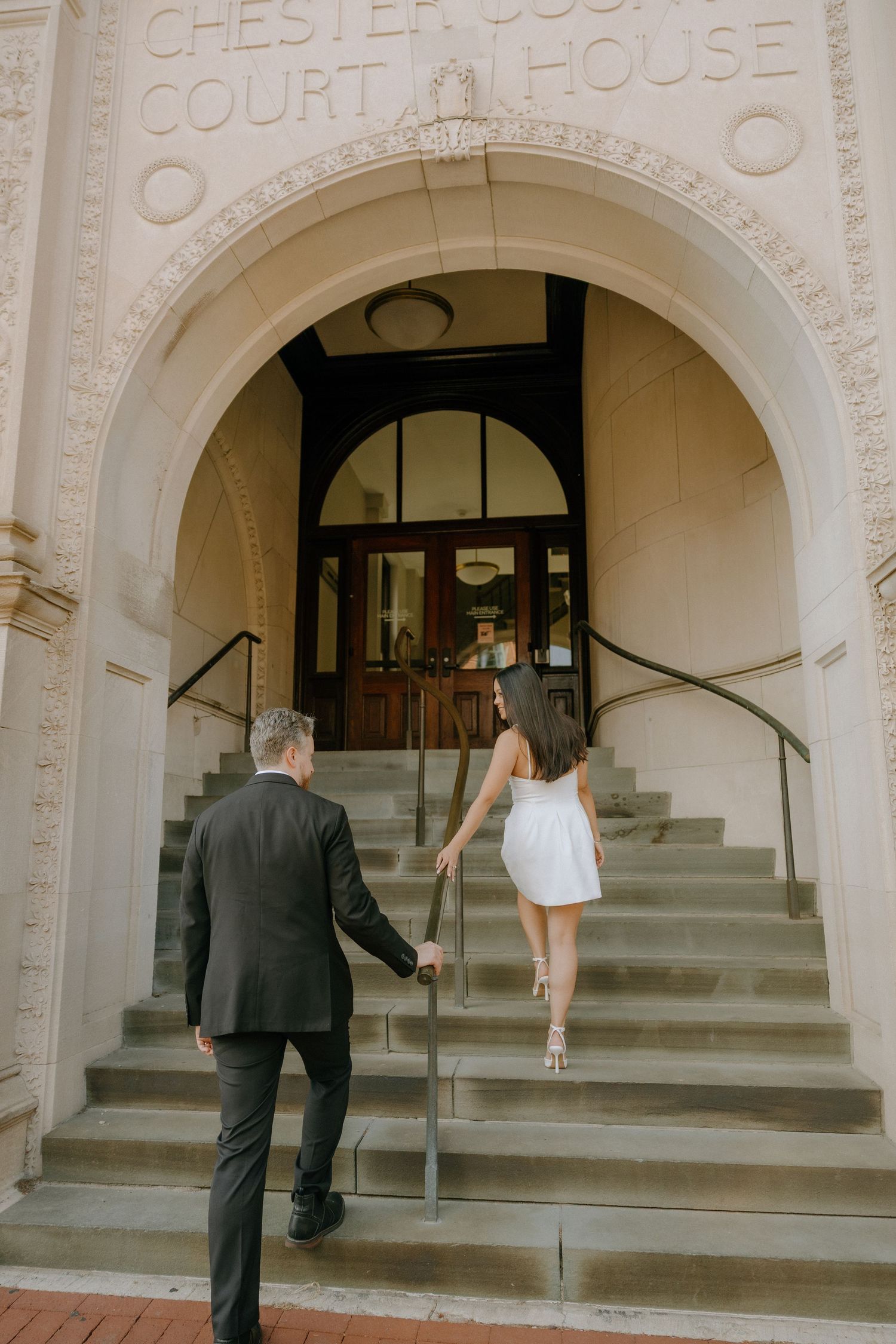 Sequential photos of people entering the Chester Courthouse through its grand arched entrance.