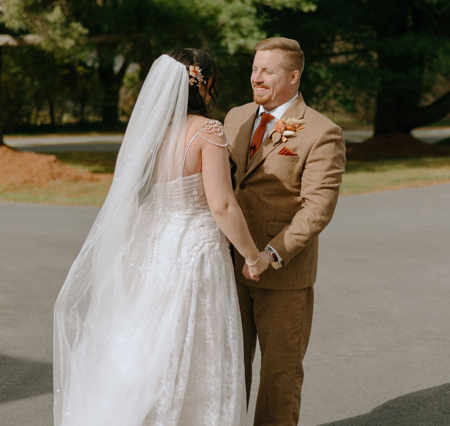 A couple shares an intimate moment during their wedding ceremony outdoors.