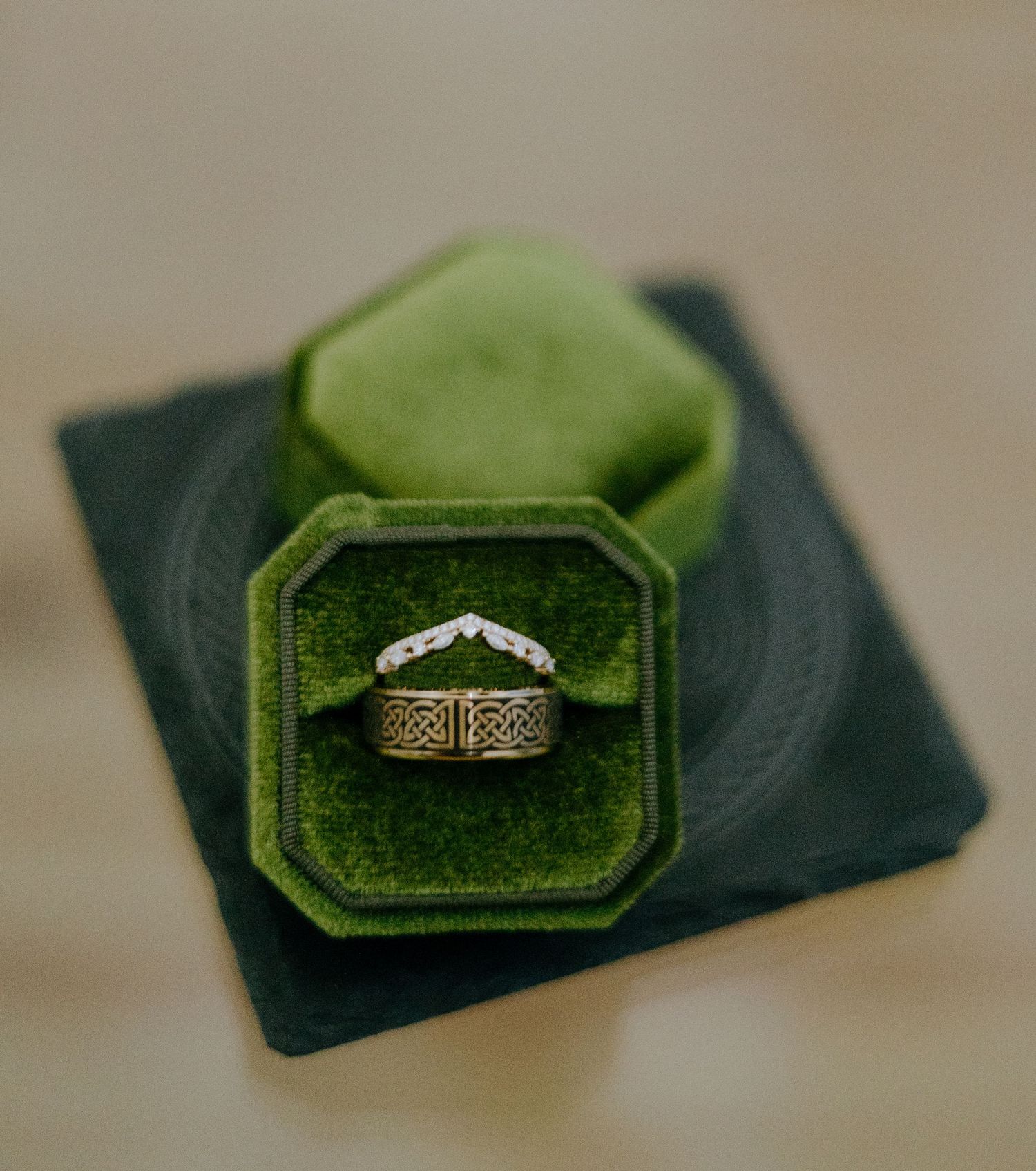 Wedding ring displayed in green velvet vintage-style octagonal ring box.