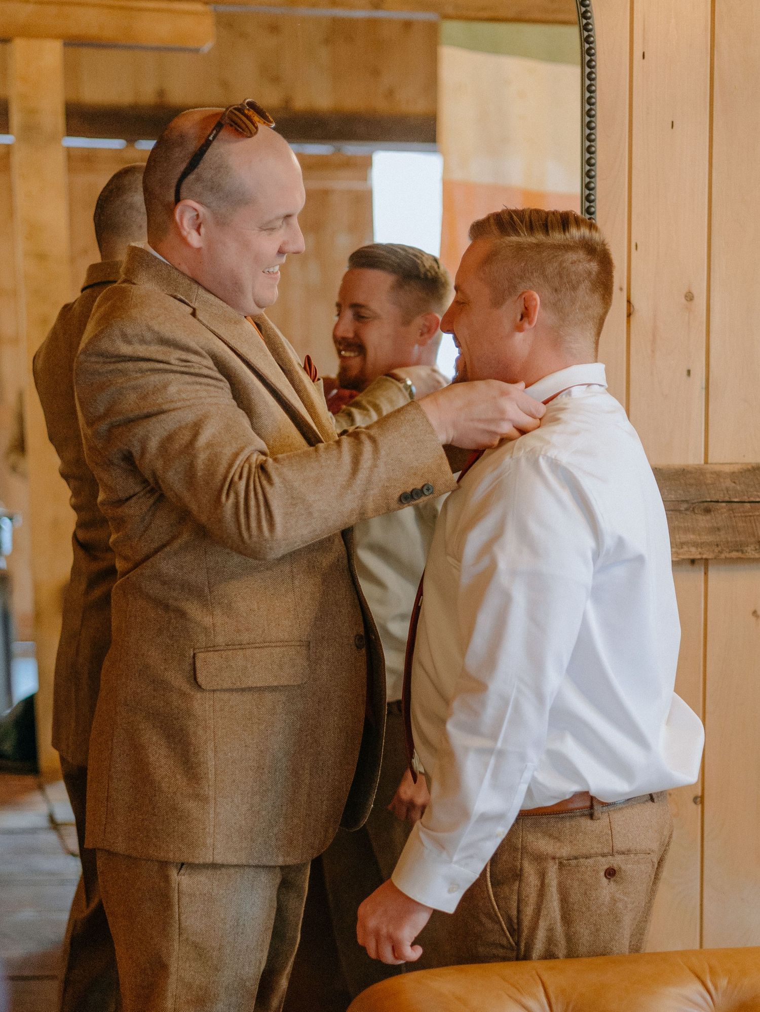 A series of candid moments showing two people in formal attire embracing in a rustic wooden interior.