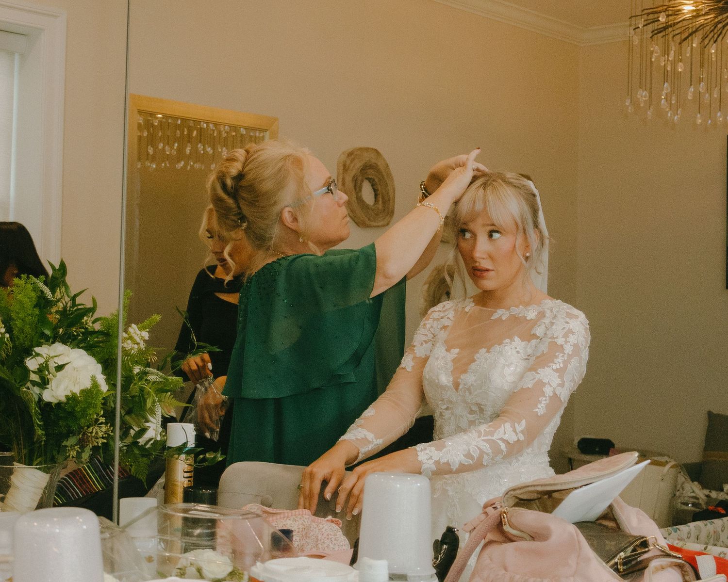 A wedding party gathers around a table signing documents and preparing for the ceremony.