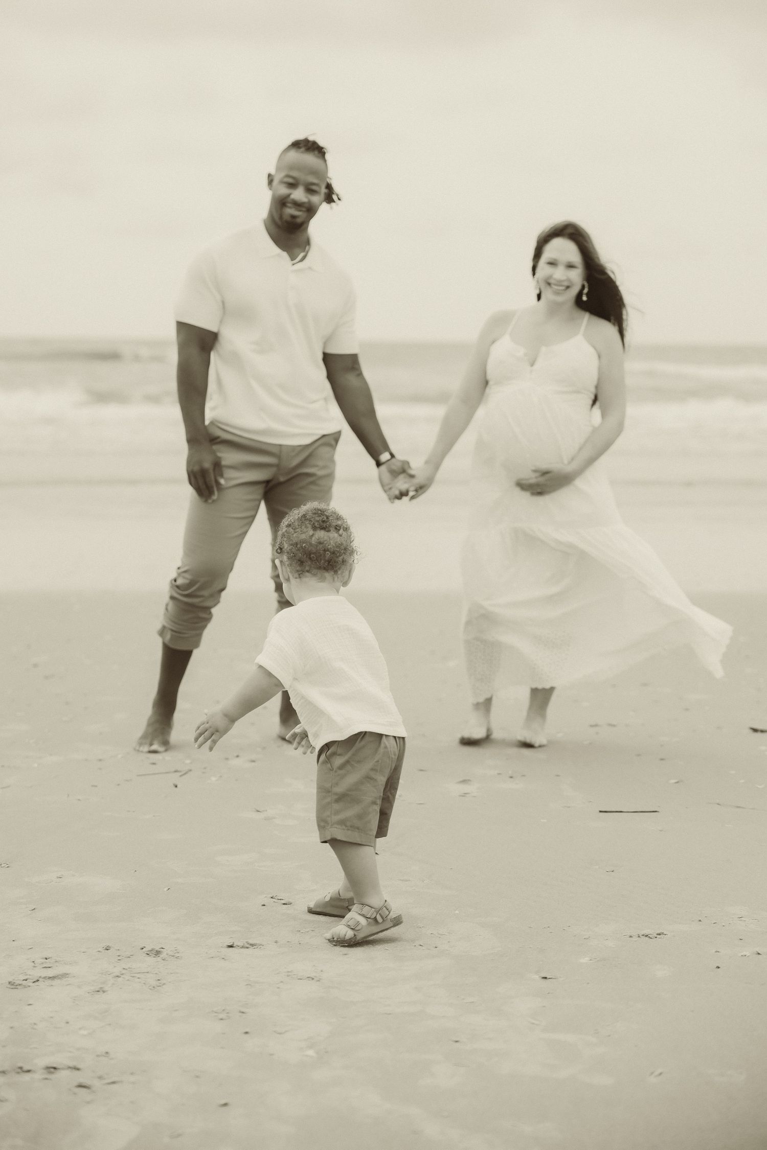 Black and white series of candid family moments captured on a beach.