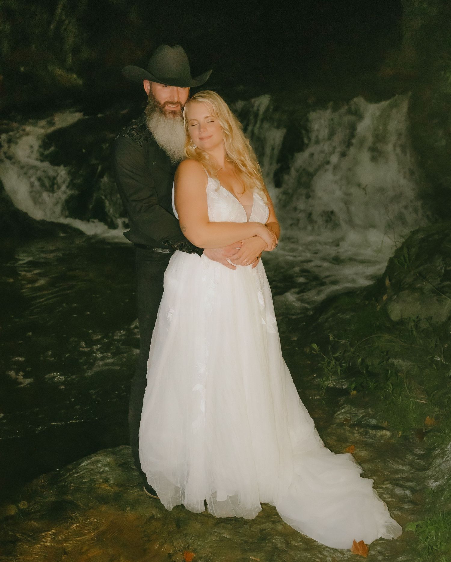 Romantic wedding photography sequence in a dimly lit stone interior.