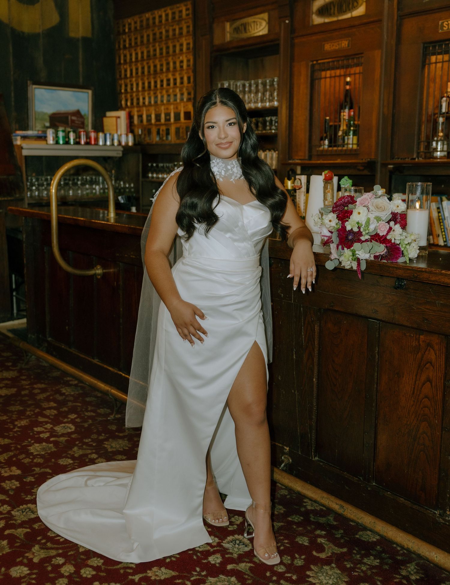 An elegant bridal photoshoot in a classic bar interior with wooden fixtures and carpeted flooring.
