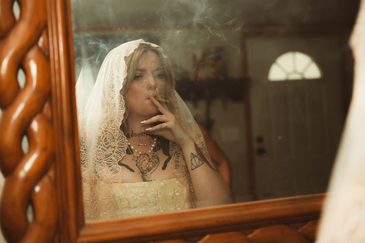 Reflective mirror shots showing details of a wedding dress and veil in warm lighting.