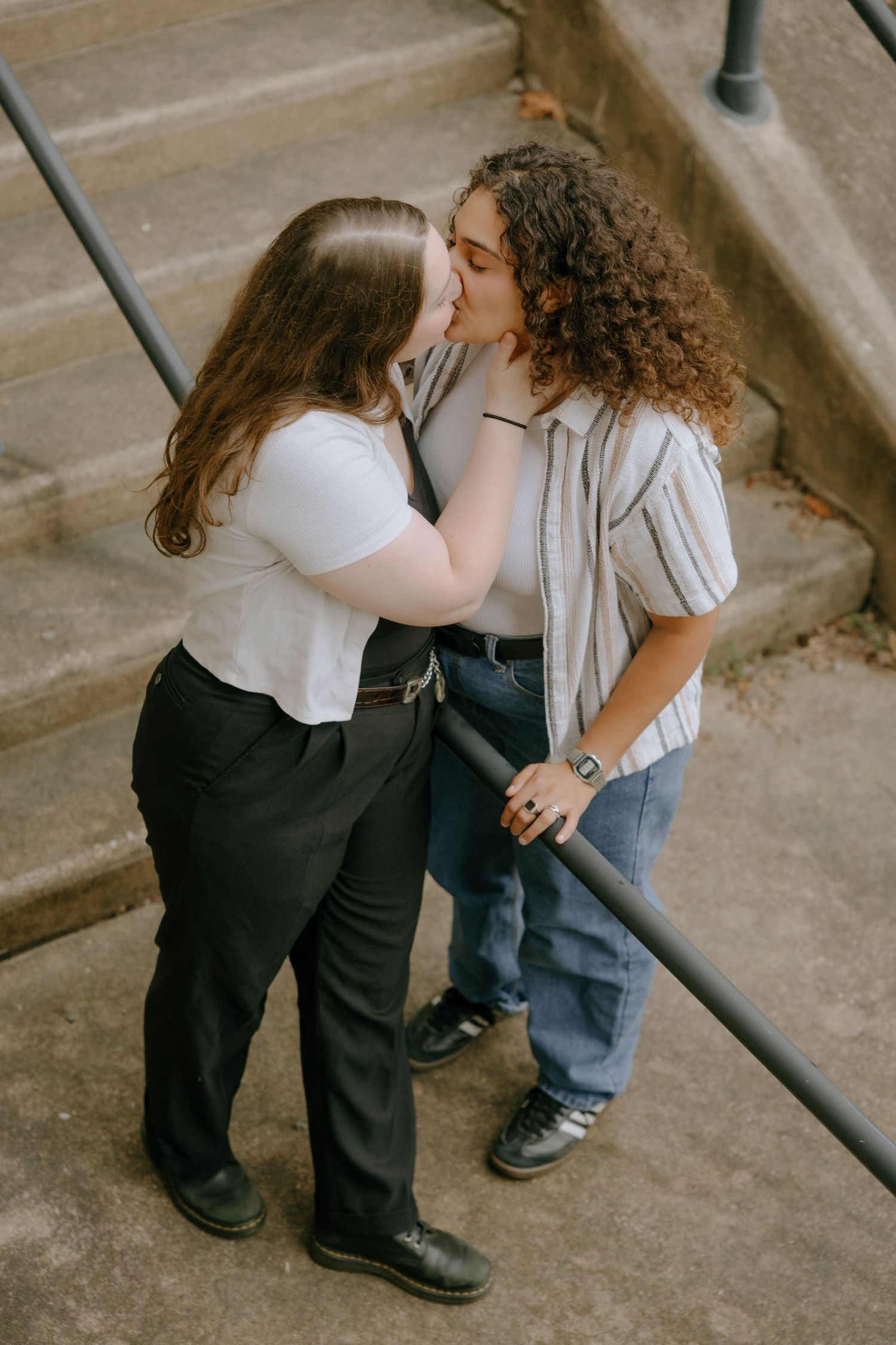 A tender moment captured on concrete steps with railing.