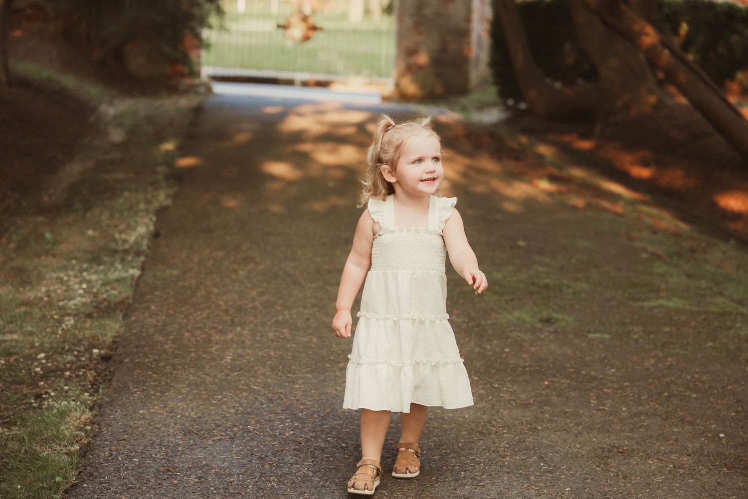 Series of joyful outdoor portraits on garden pathway.