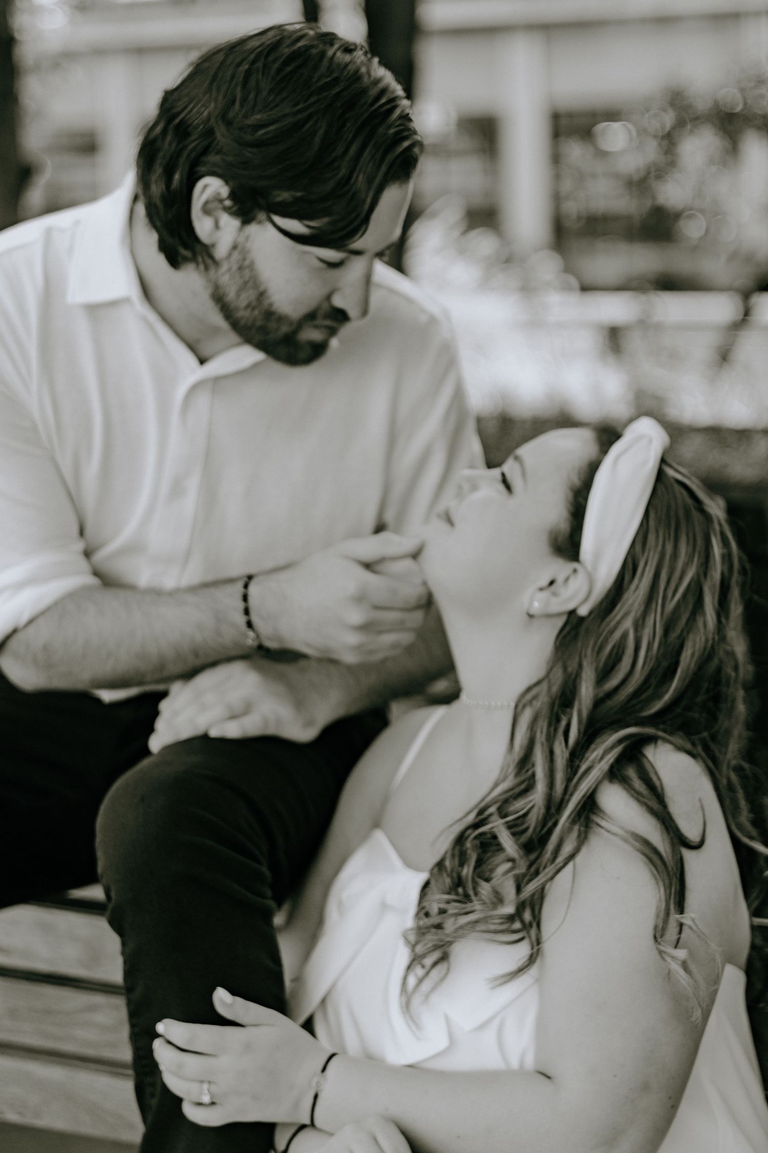 A romantic black and white photo series showing tender moments of affection and intimacy between a couple.