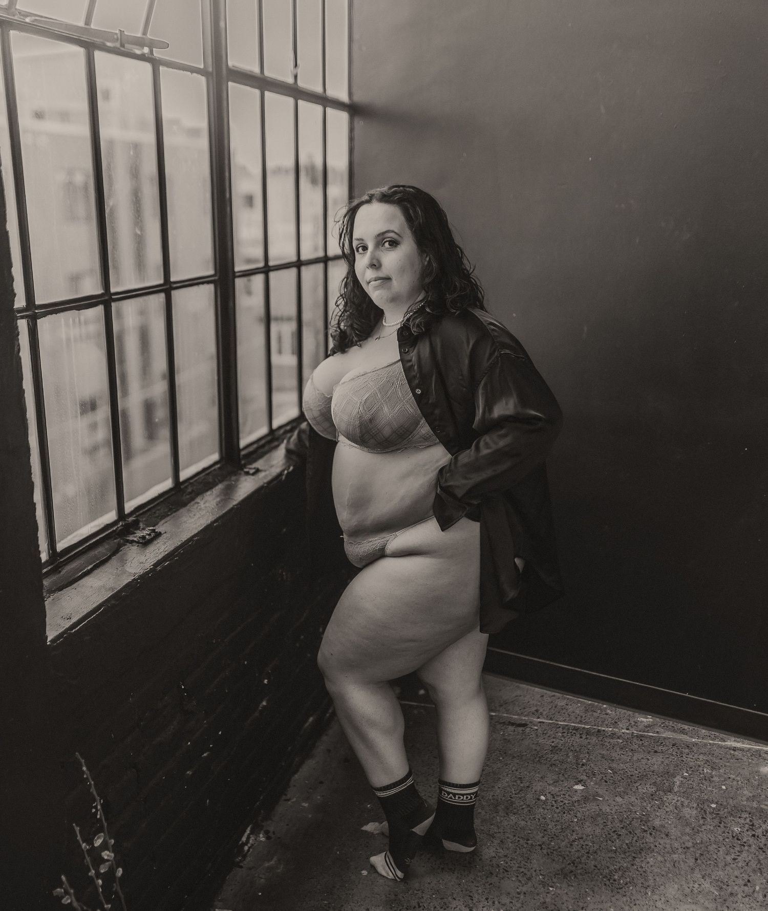 Black and white artistic photography in industrial window setting.