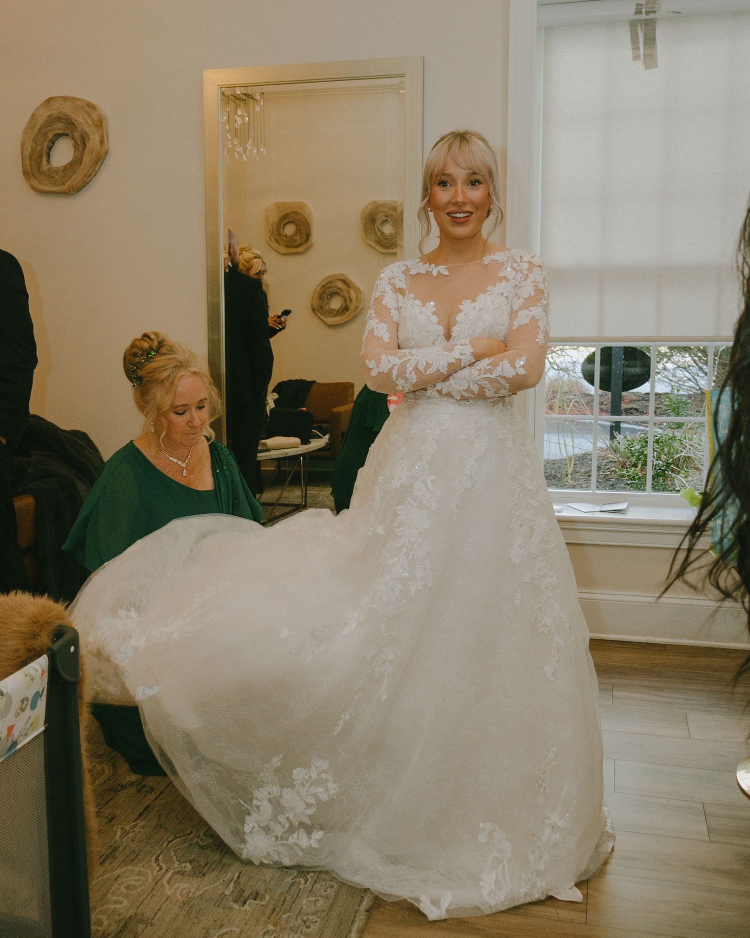 A series of bridal preparation photos showing a flowing white wedding dress with delicate lace details in an elegant room.