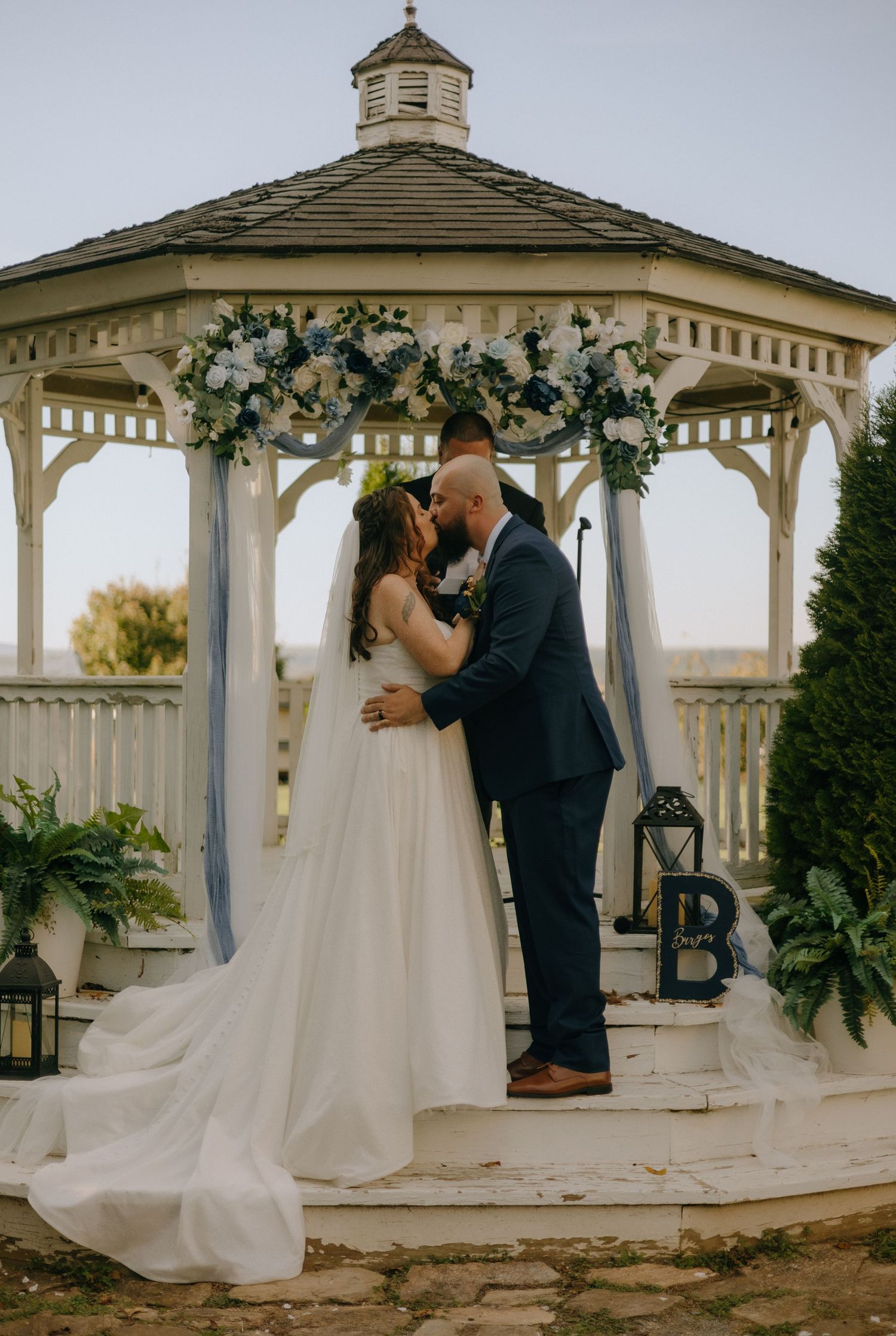 A romantic wedding couple shares intimate moments in a white gazebo during sunset, captured in a series of photos.
