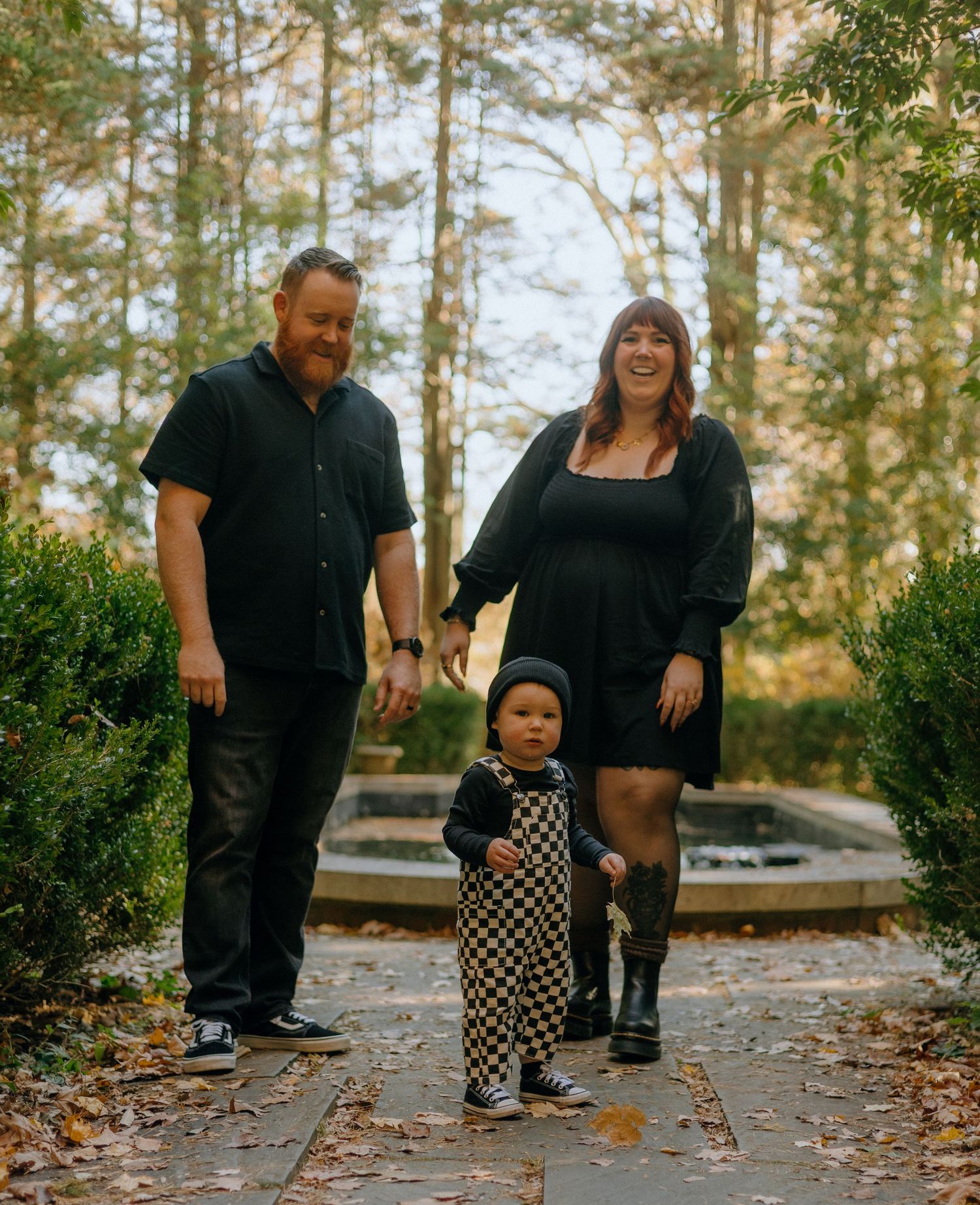 A series of playful moments captured on a leaf-covered path in a wooded area during autumn.