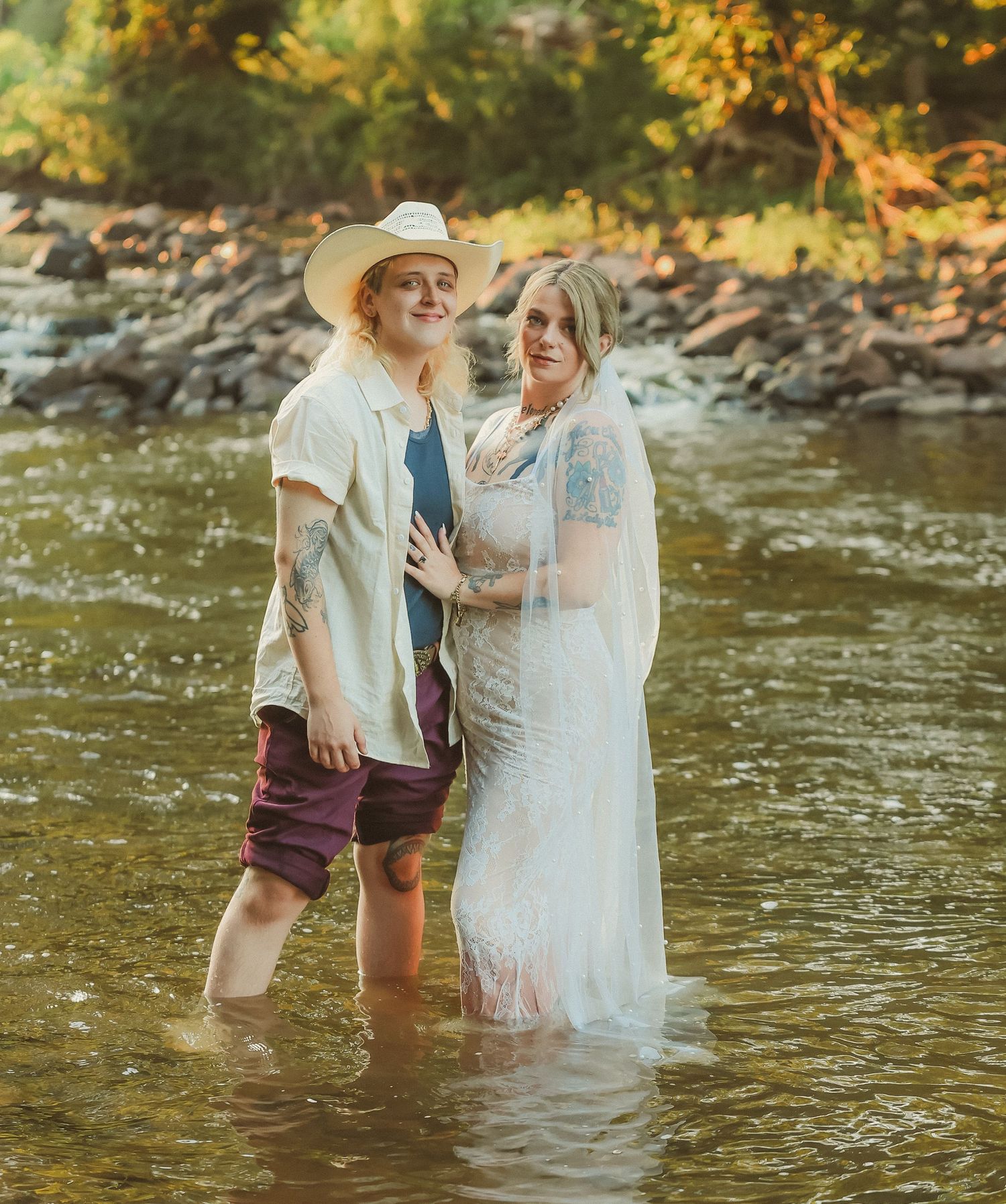 A couple shares an intimate moment while standing in a river during their wedding.