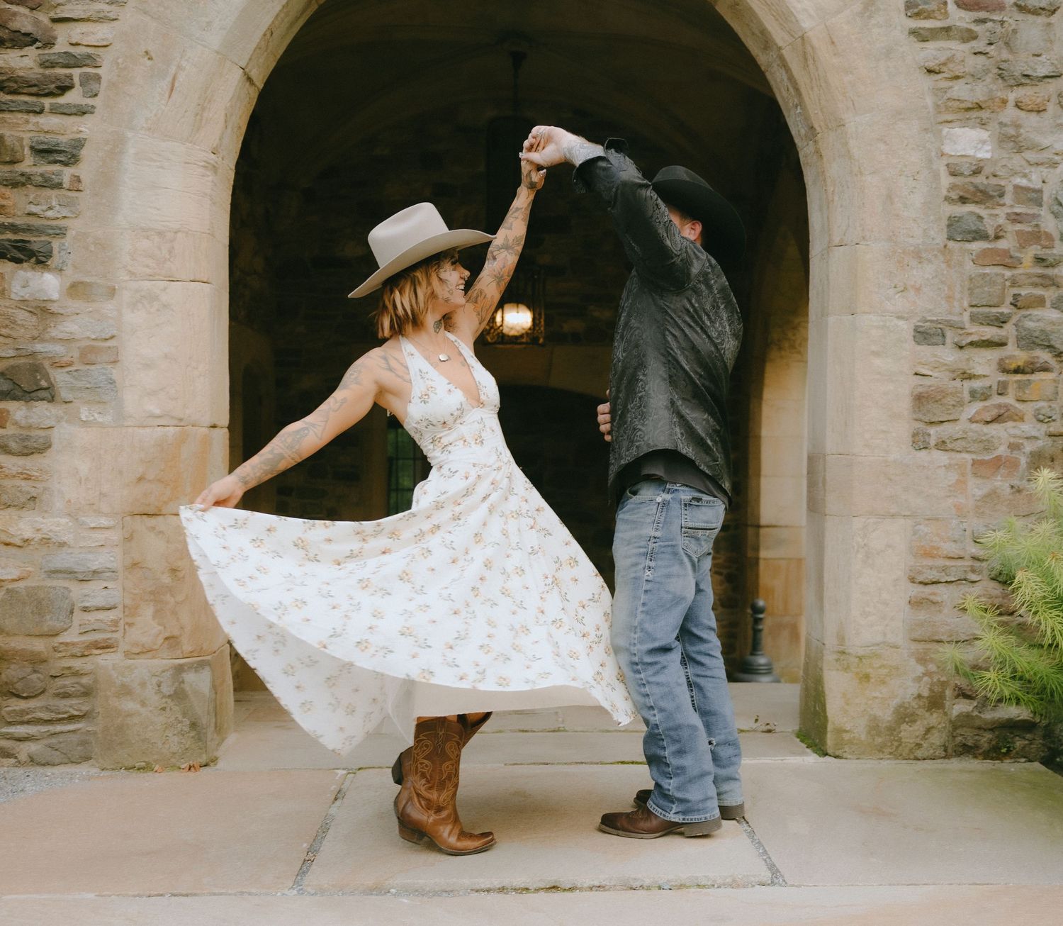 Playful moments under stone archways at a historic building entrance.