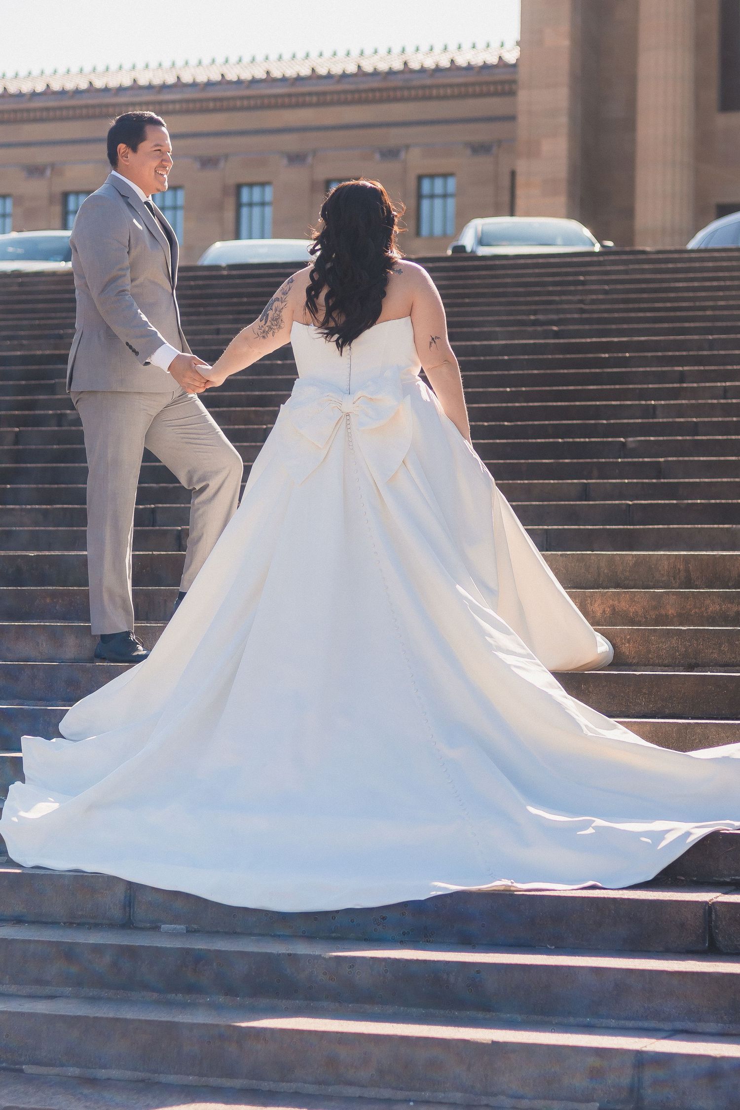 A couple dances on stone steps during their wedding photoshoot.