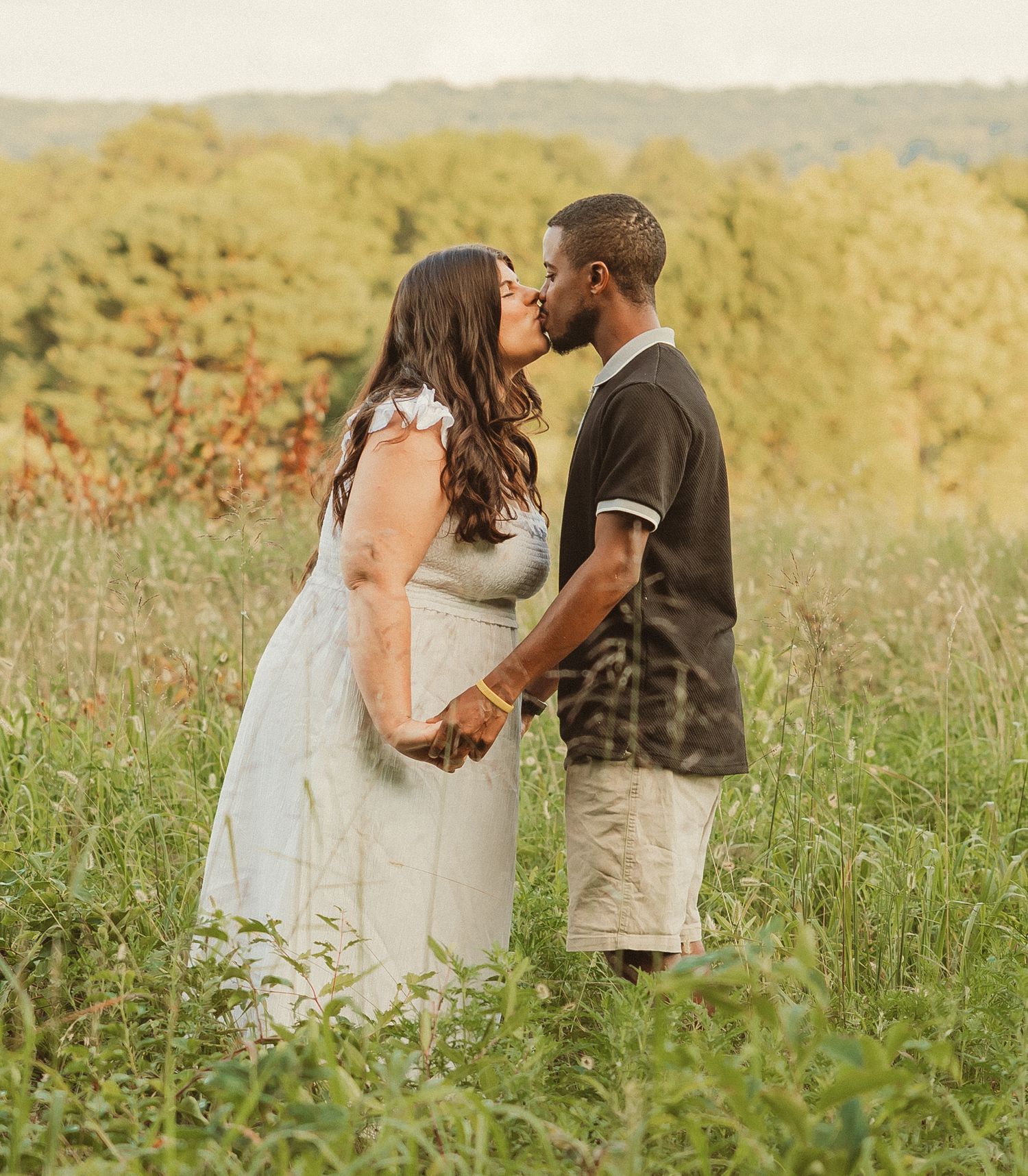A romantic moment shared in a wildflower meadow at golden hour.