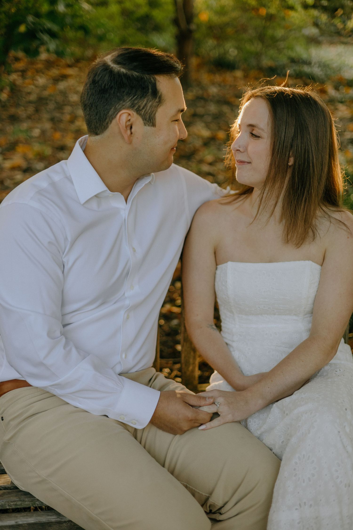 Romantic couple in white and khaki share tender moments during an autumn outdoor photoshoot.