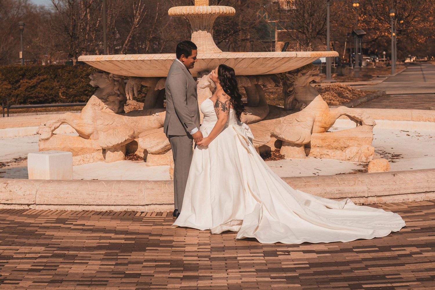 Romantic wedding photo series on stone steps in warm sunlight.
