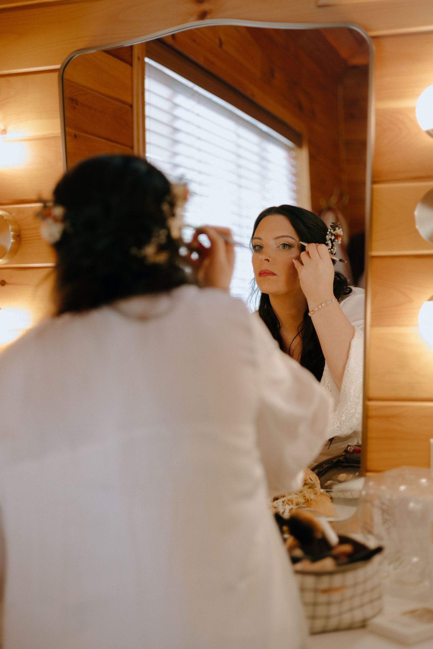 Getting ready scene in rustic wood-paneled room with morning light streaming through windows.