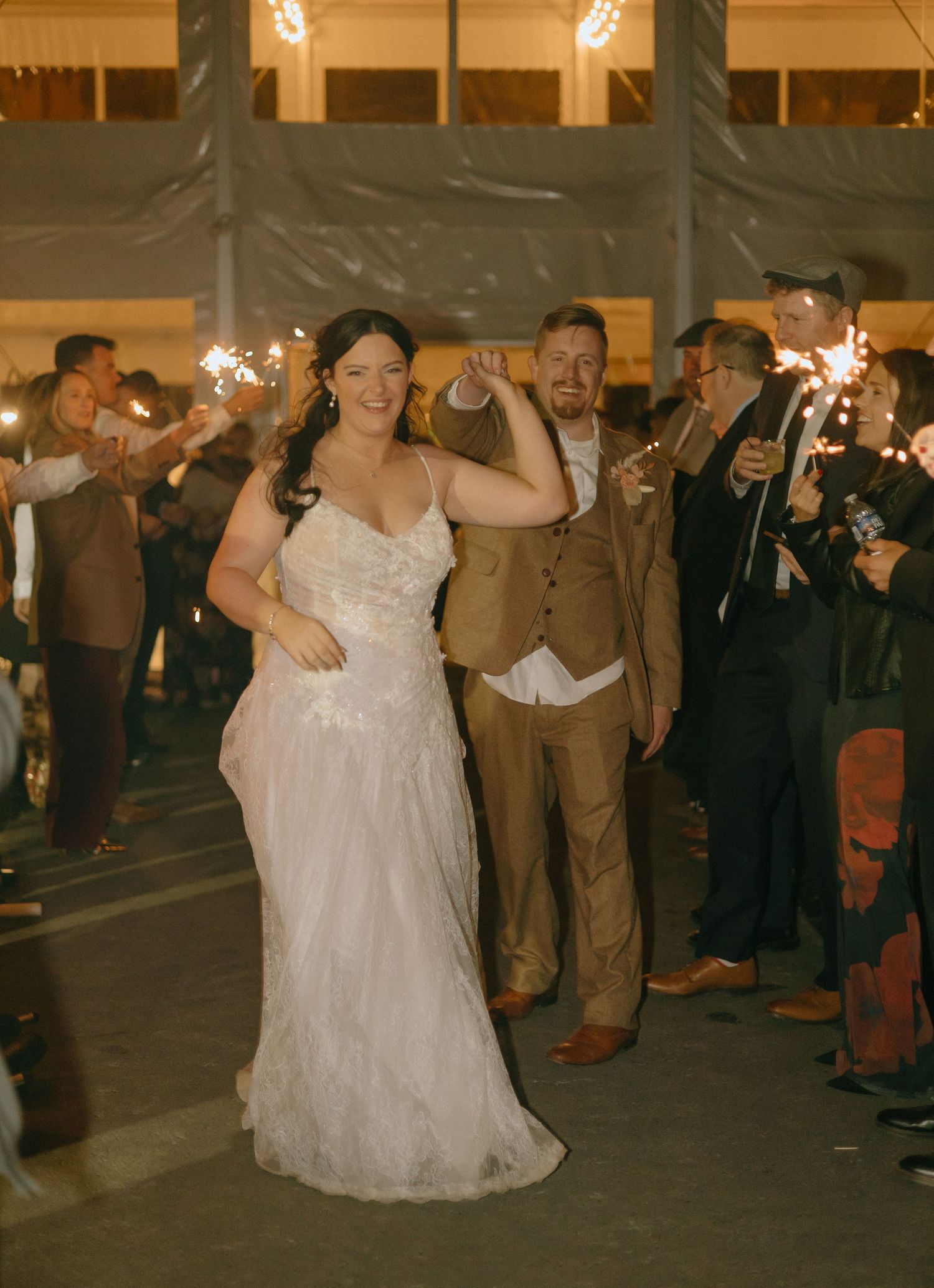 Evening wedding reception with dancing and sparklers creating festive atmosphere.