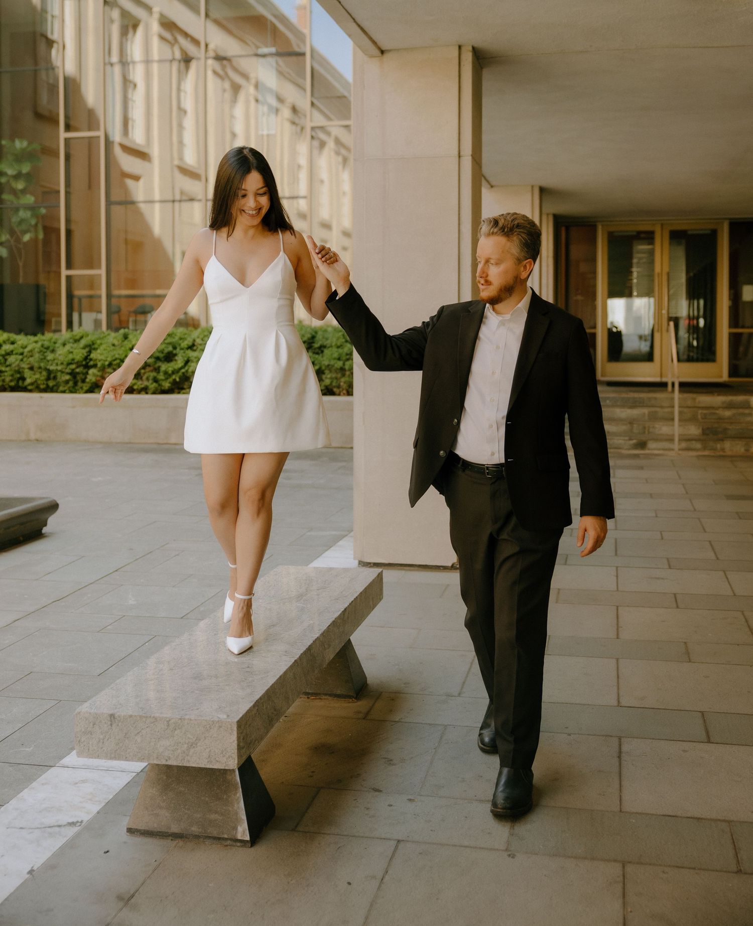 Artistic sequence of dance moves along stone pathway at elegant building.