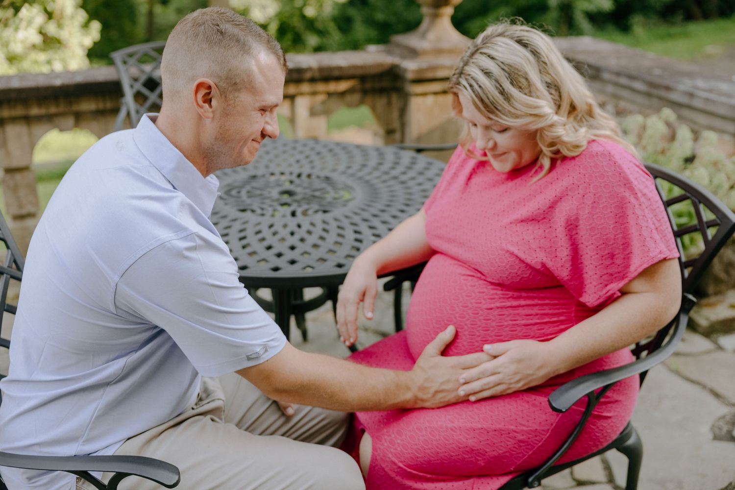 Sweet candid moment captured of family members on outdoor bench in coordinated outfits.