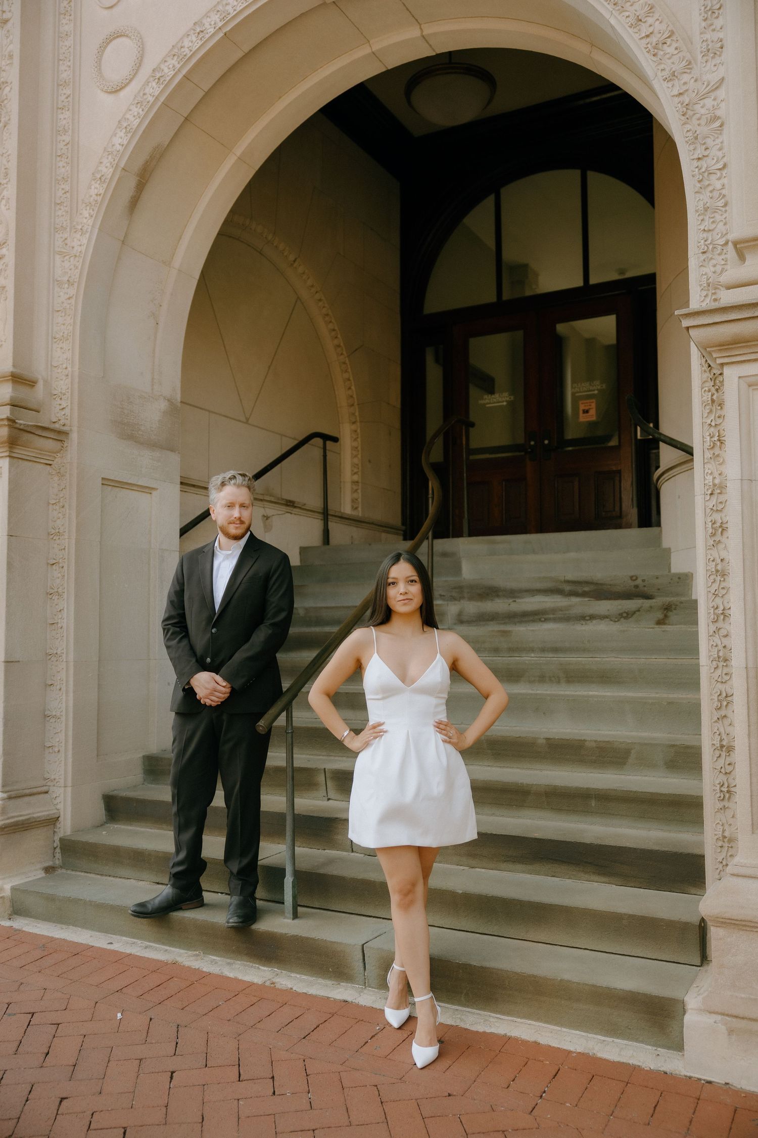 Four-part photo series capturing poses and interactions at a courthouse entrance with classical architecture.