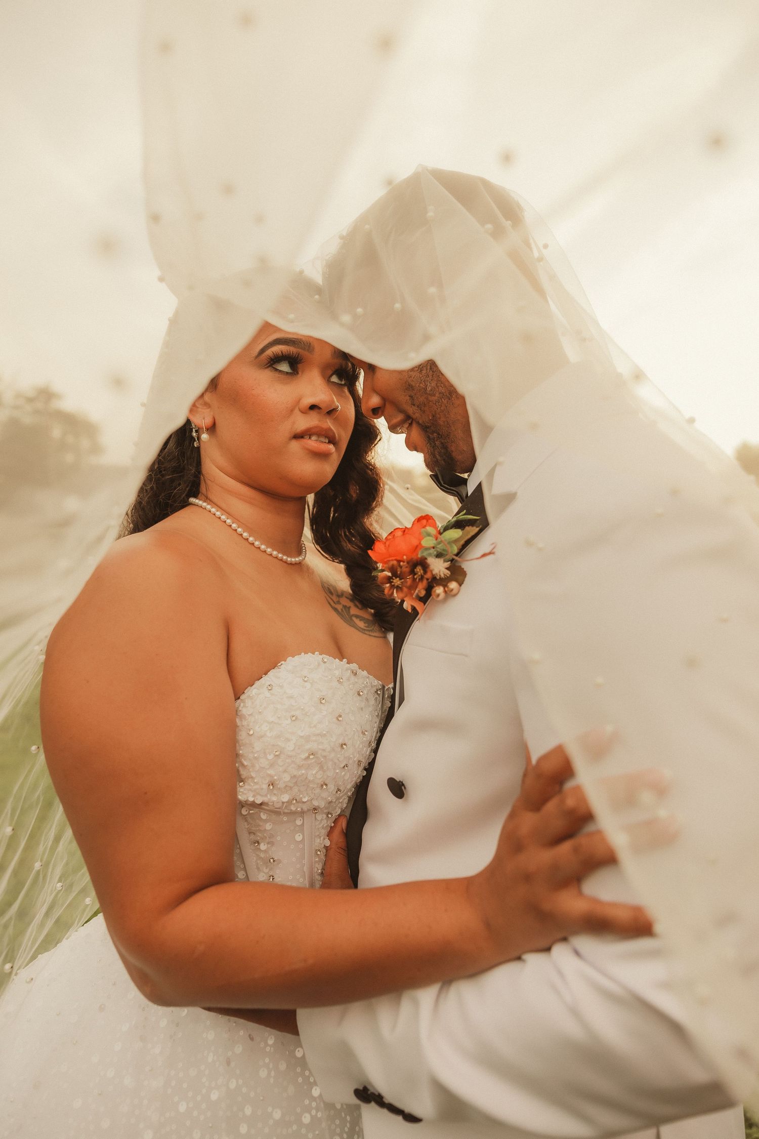 Close-up wedding photography captures intimate moments between a couple in formal attire.