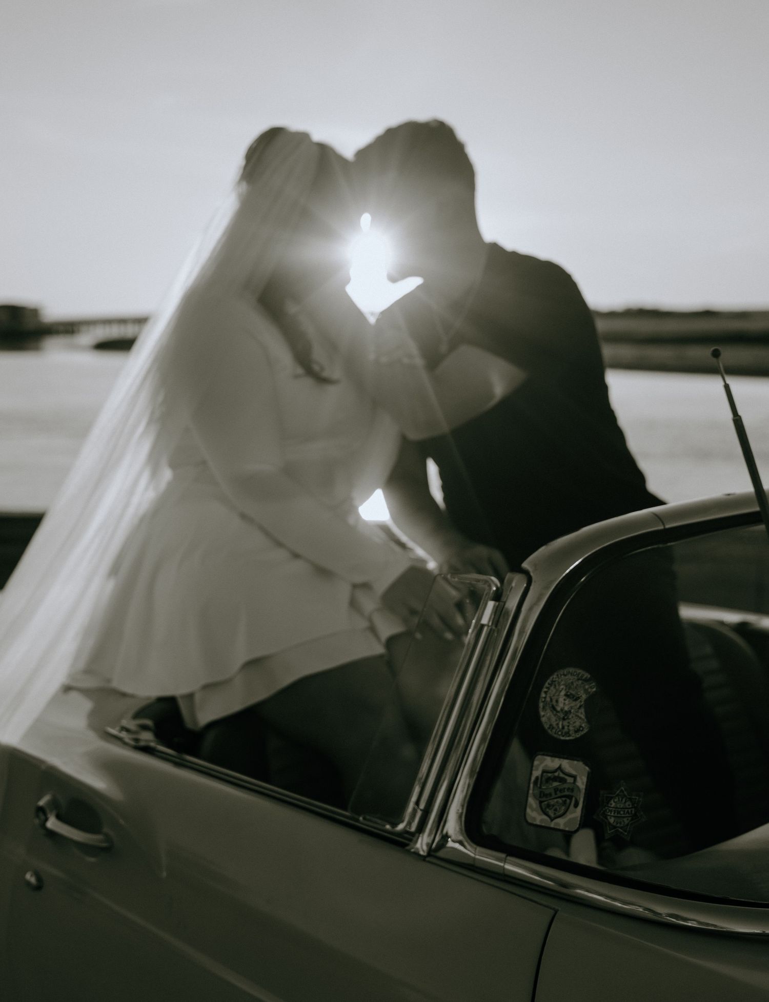 A series of five black and white photos showing someone getting into a car in a film noir style sequence.