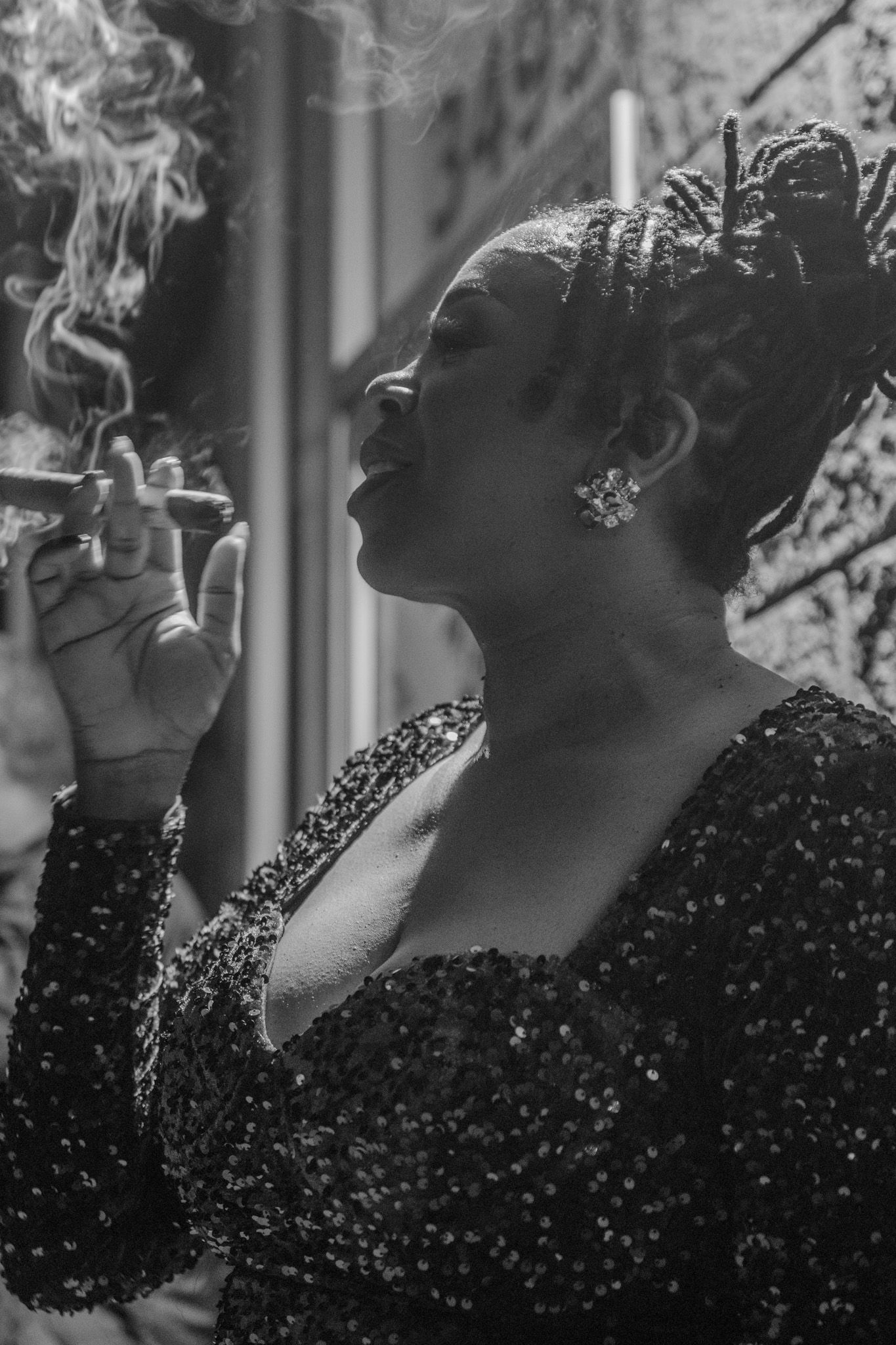 Artistic black and white photo capturing smoke exhaled in profile view.