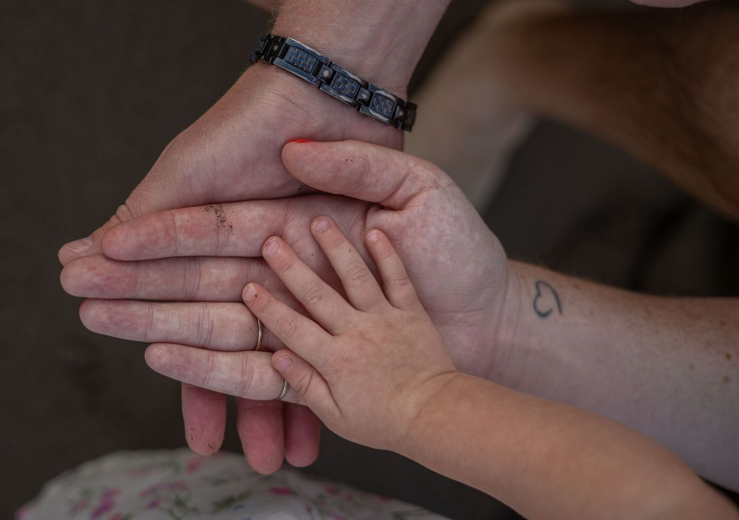 Close up of hands gently touching and intertwining.