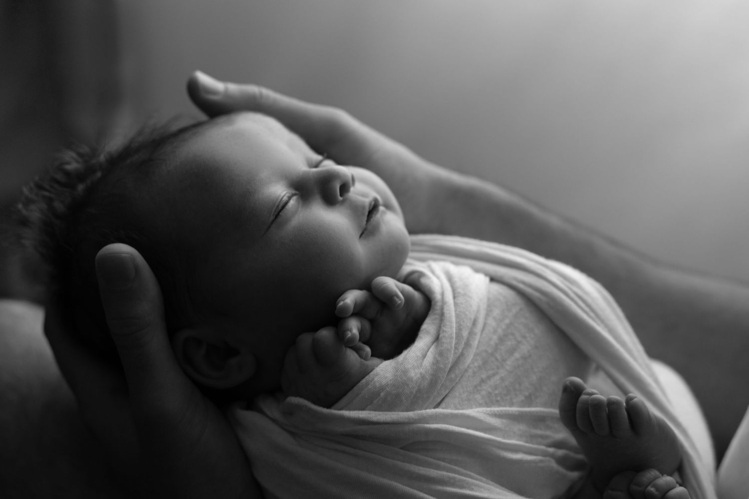 A series of black and white photos showing a person lying down with closed eyes in a contemplative, peaceful pose.