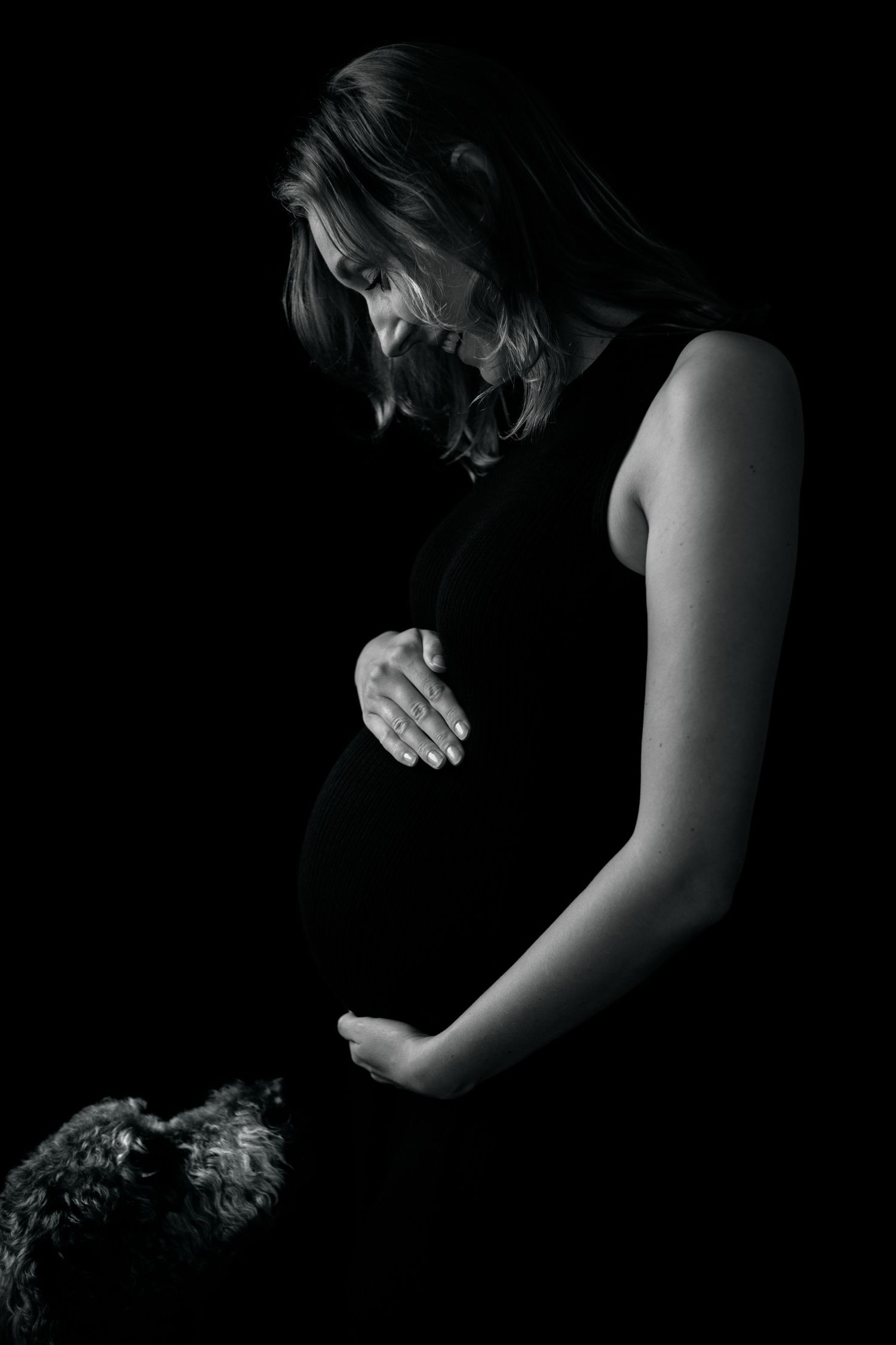A series of black and white artistic portraits showing a person in dark clothing against a black background.