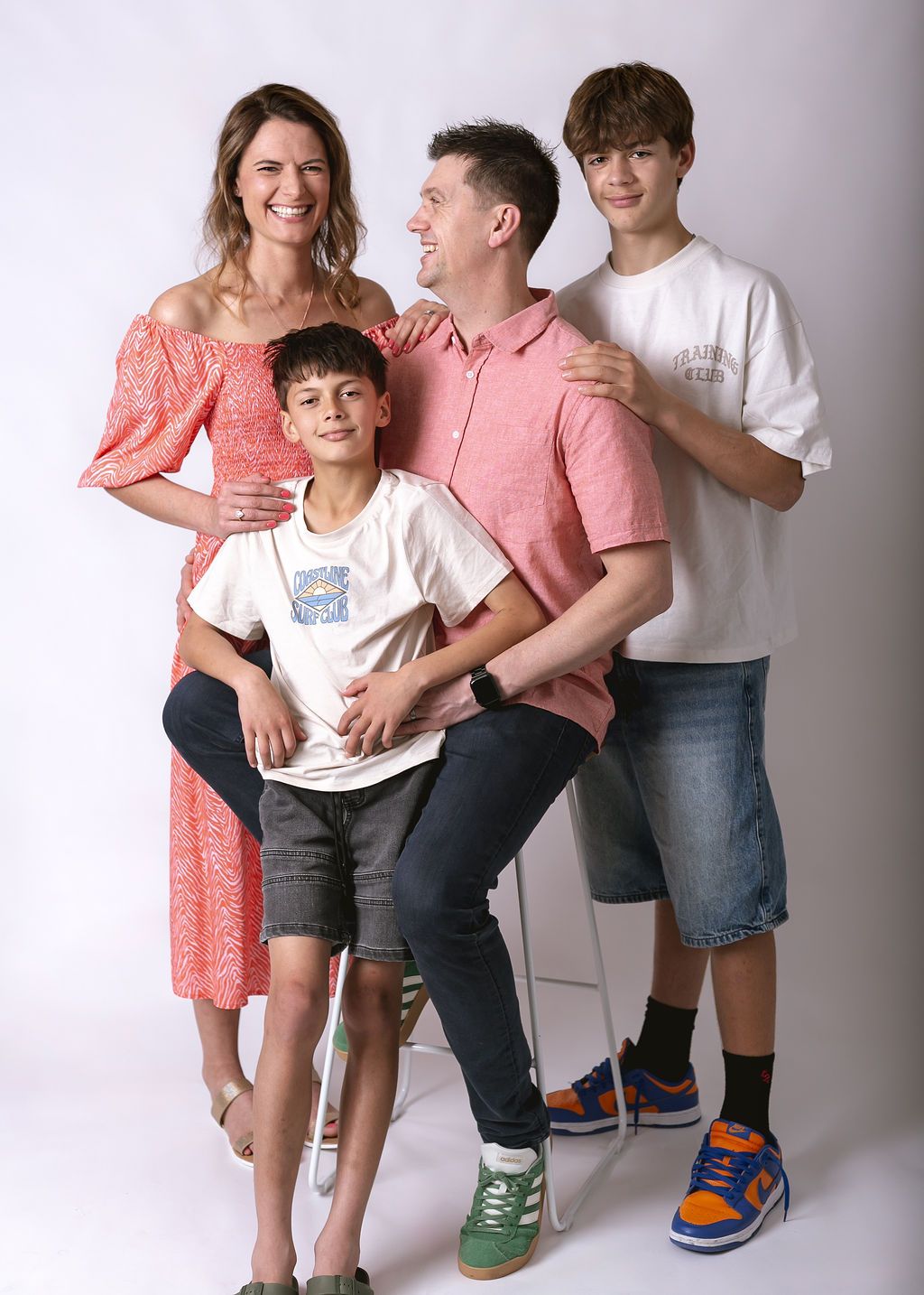 Studio portrait session showing playful poses and coordinated casual outfits at Gabriella Aranky Photography studio, Auckland.