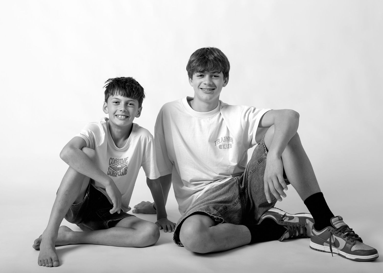 Four black and white photos showing people lying on their sides in casual poses against a white background.