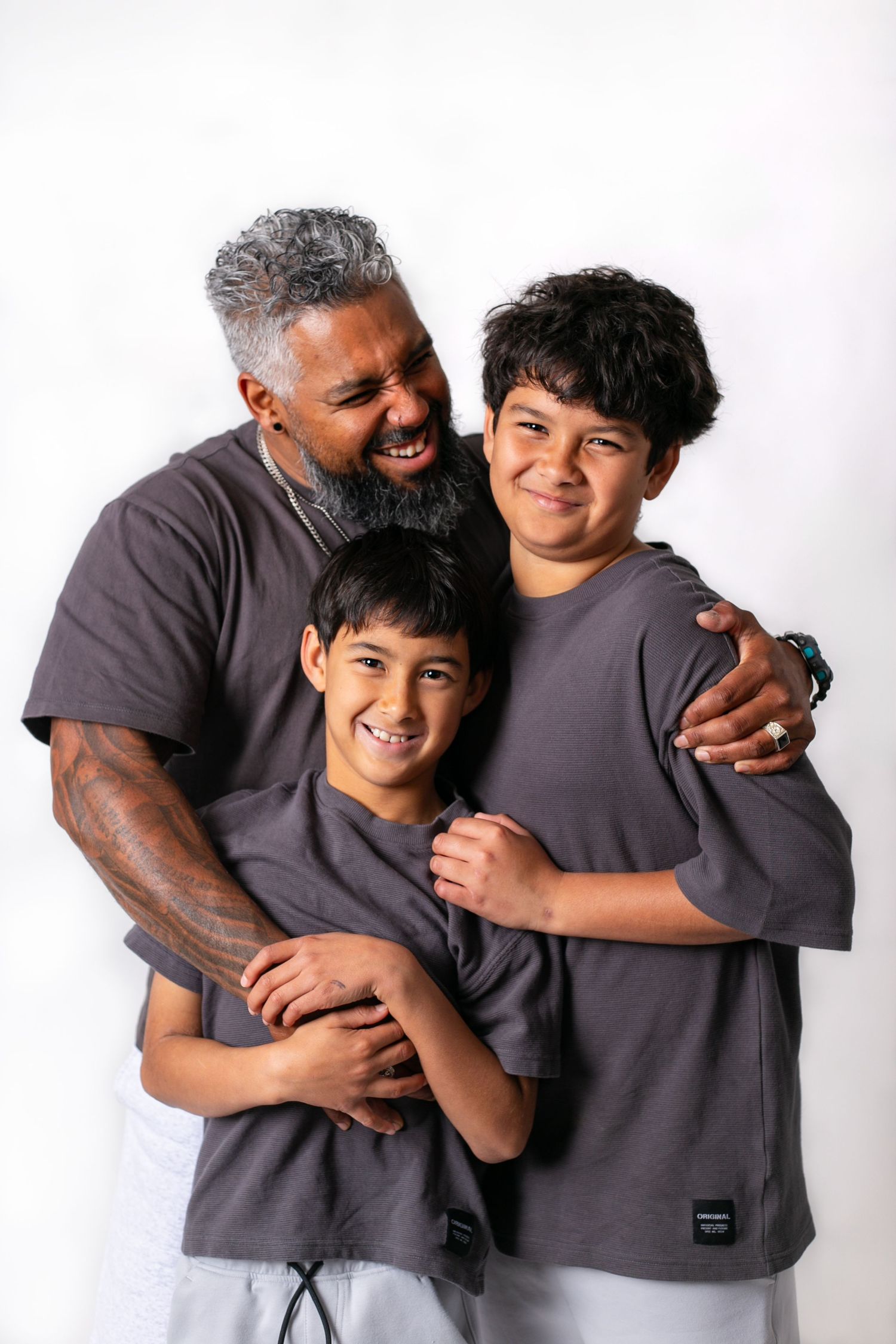 A heartwarming series of candid moments showing a parent and child wearing matching gray shirts sharing playful embraces.