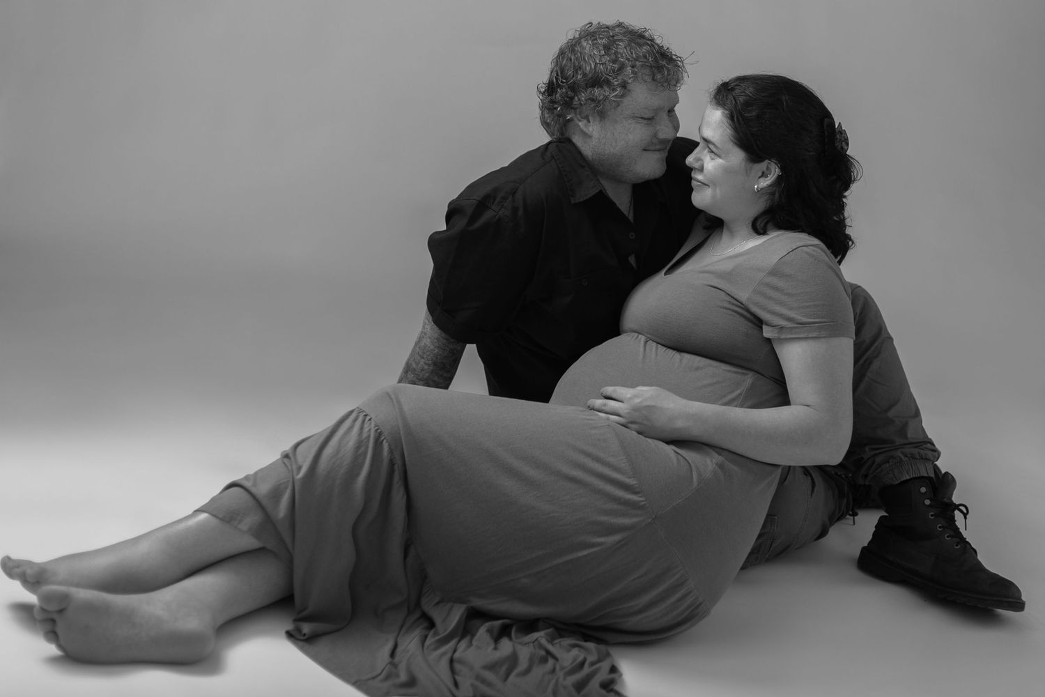 A black and white photo series showing an intimate dance sequence between two people on the floor.