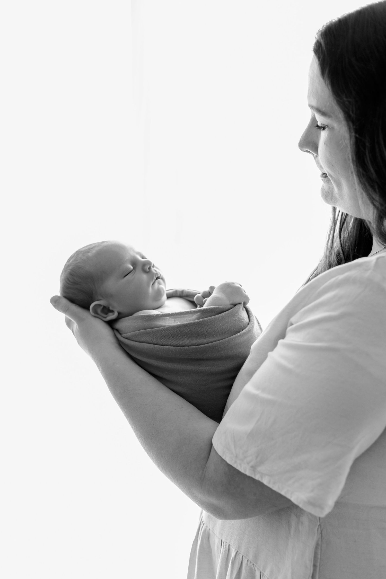 High-key portrait series showing tender moments between parent and infant.