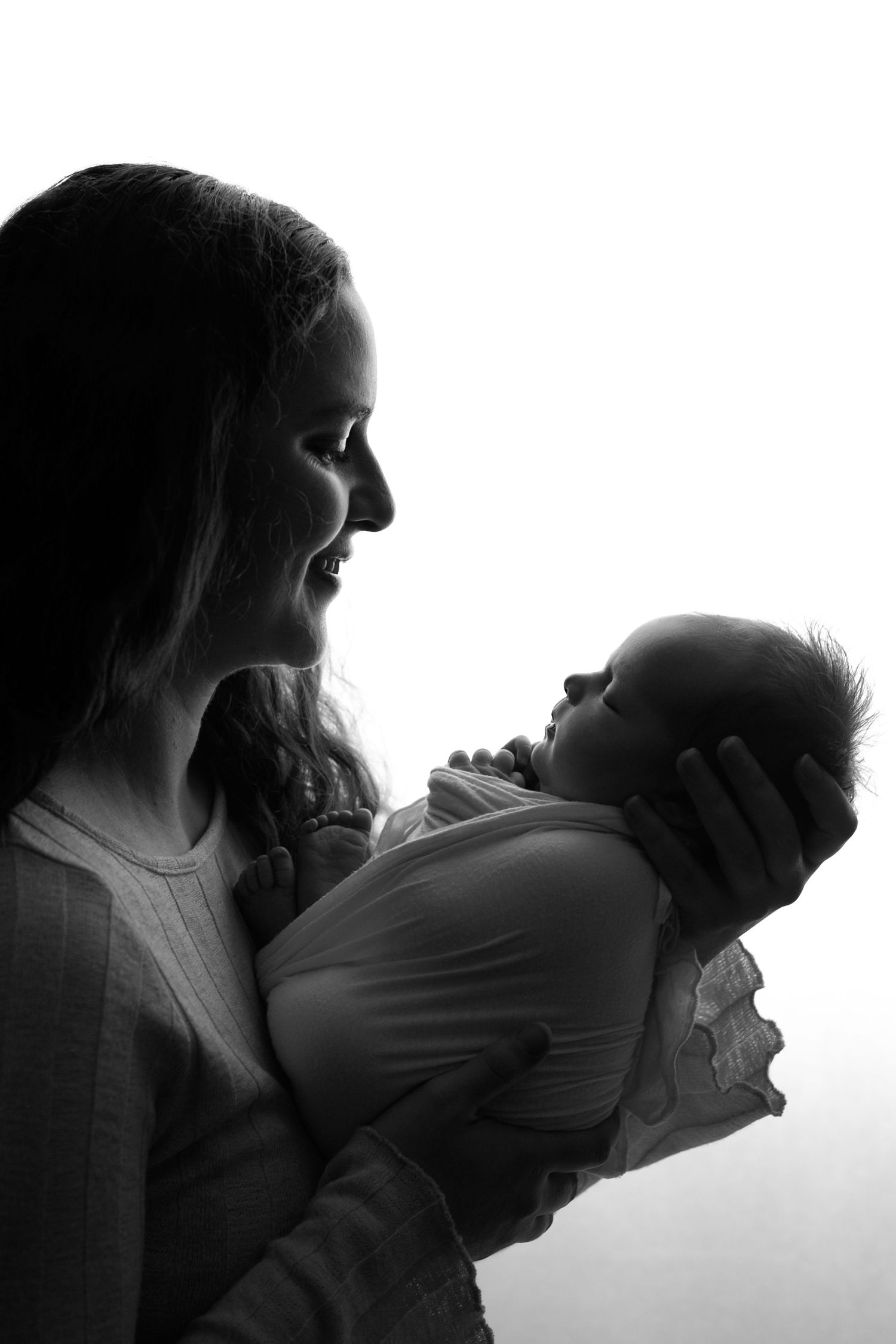 A series of black and white silhouettes showing an intimate moment between two people in profile against a white background.
