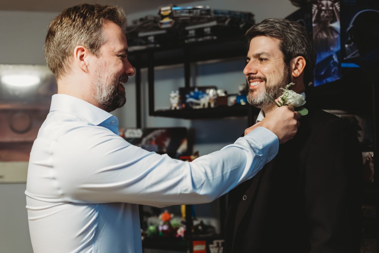 Les garçons d'honneur aident le marié à apporter les dernières touches à sa tenue.