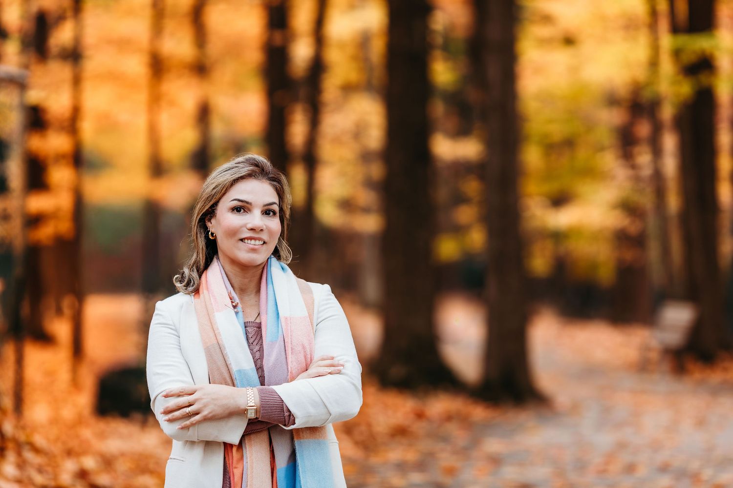 Autumn portrait photography session in a forest with golden sunlight filtering through trees.
