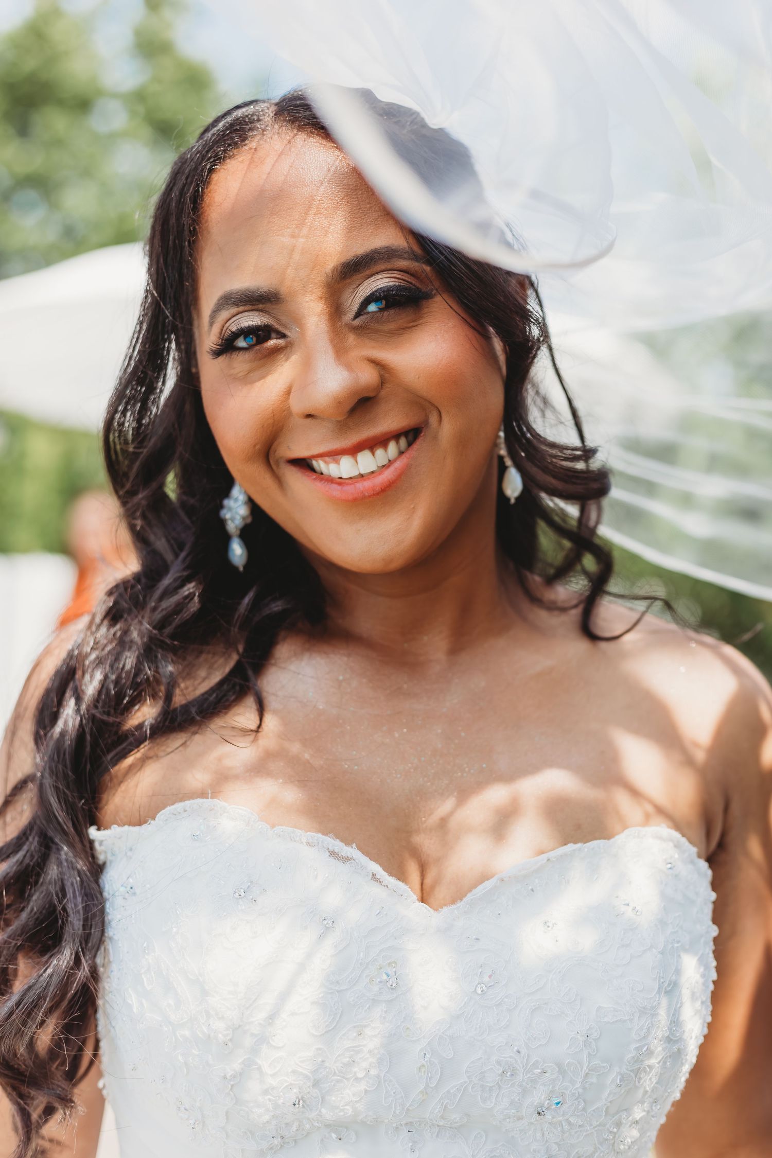 Beautiful bridal portraits showing a sparkling white wedding dress and natural lighting.