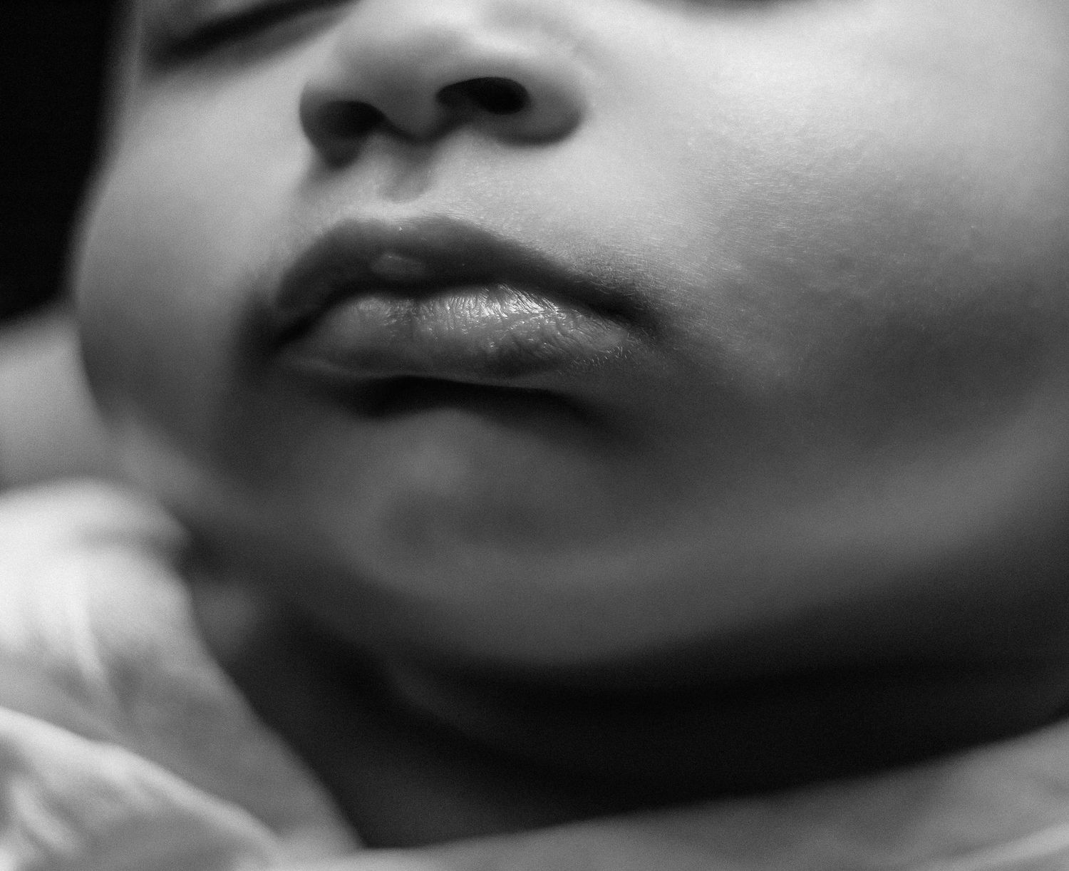 A series of black and white close-up photos showing lips and the lower part of faces in different expressions.