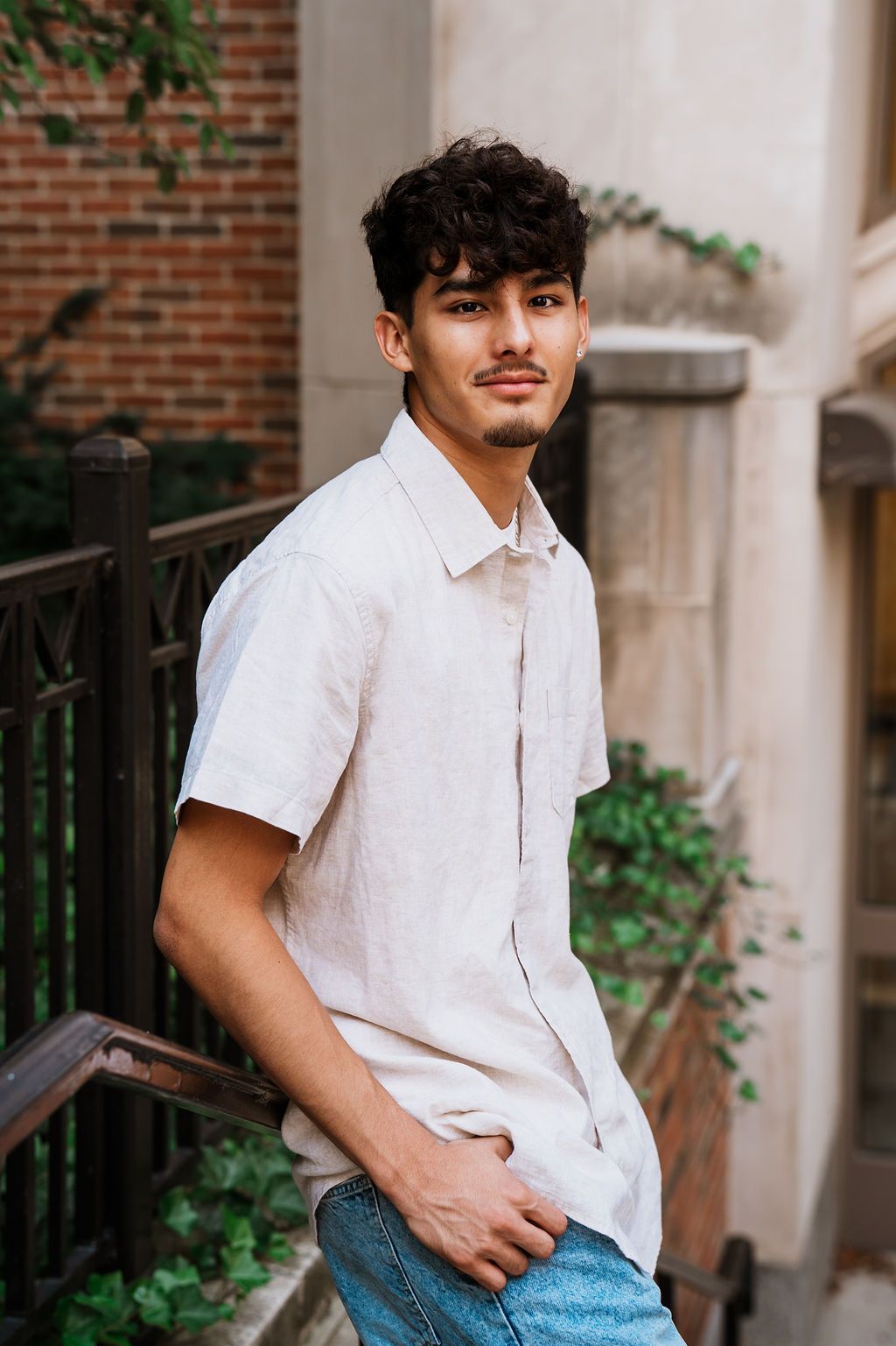 Casual summer portrait session against brick architecture wearing a white button-down shirt. Ann Arbor senior photos, Canton high school